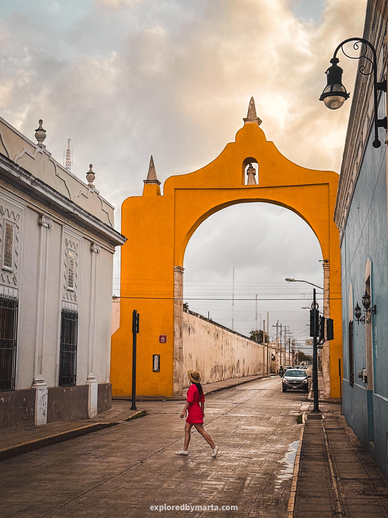 Merida, Mexico-Arco de Dragones yellow colonial arch stretching over a street in Merida, Mexico