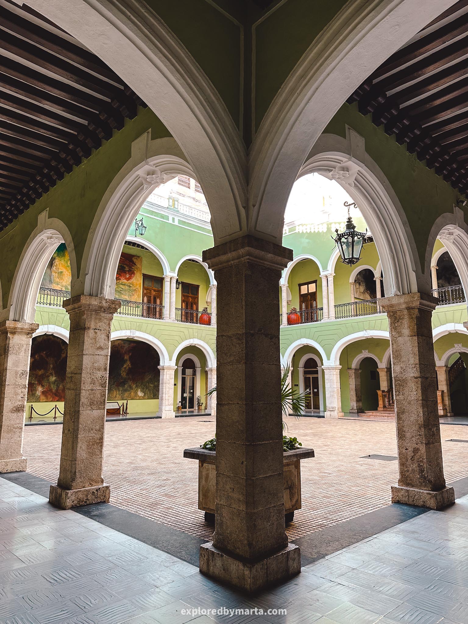 Merida, Mexico - Palacio de Gobierno del Estado de Yucatán - a green 19th century government building with arcaded courtyard and murals on the walls