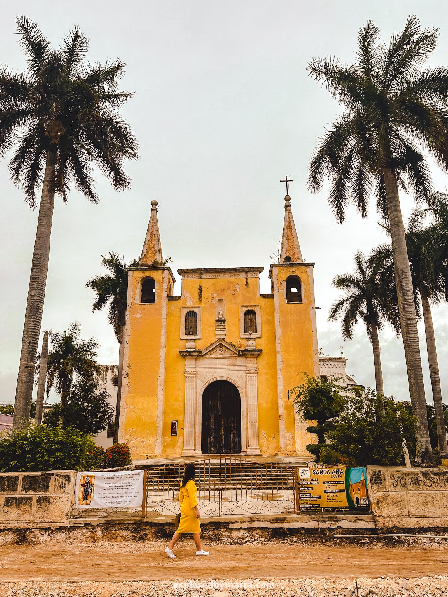 Merida, Mexico-photo perfect colorful houses and a yellow church with two spires in Parque de Santa Ana in Merida, Mexico