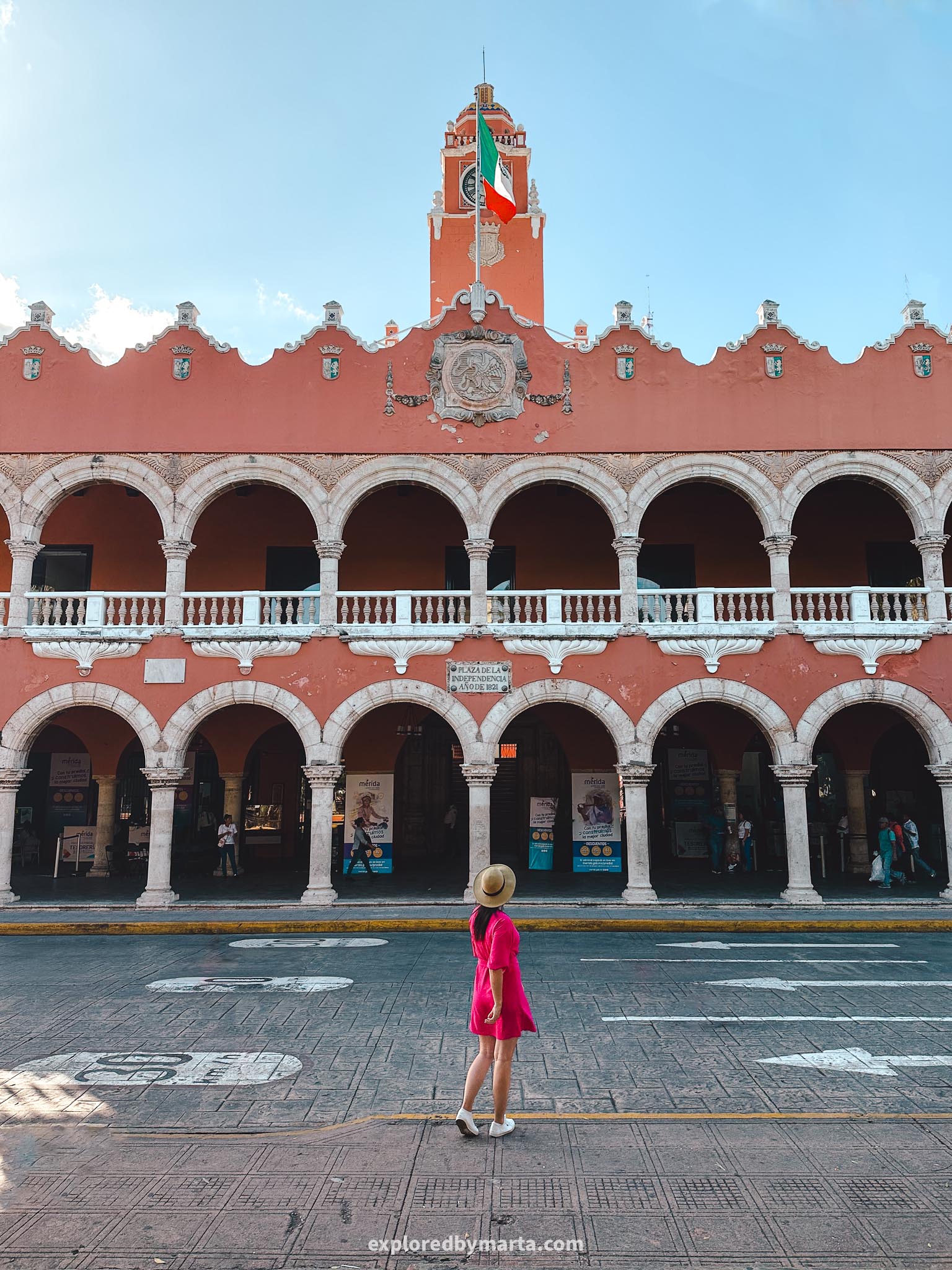 Merida, Mexico - the red-colored Palacio Municipal de Mérida palace featuring archways and views over Plaza Grande square