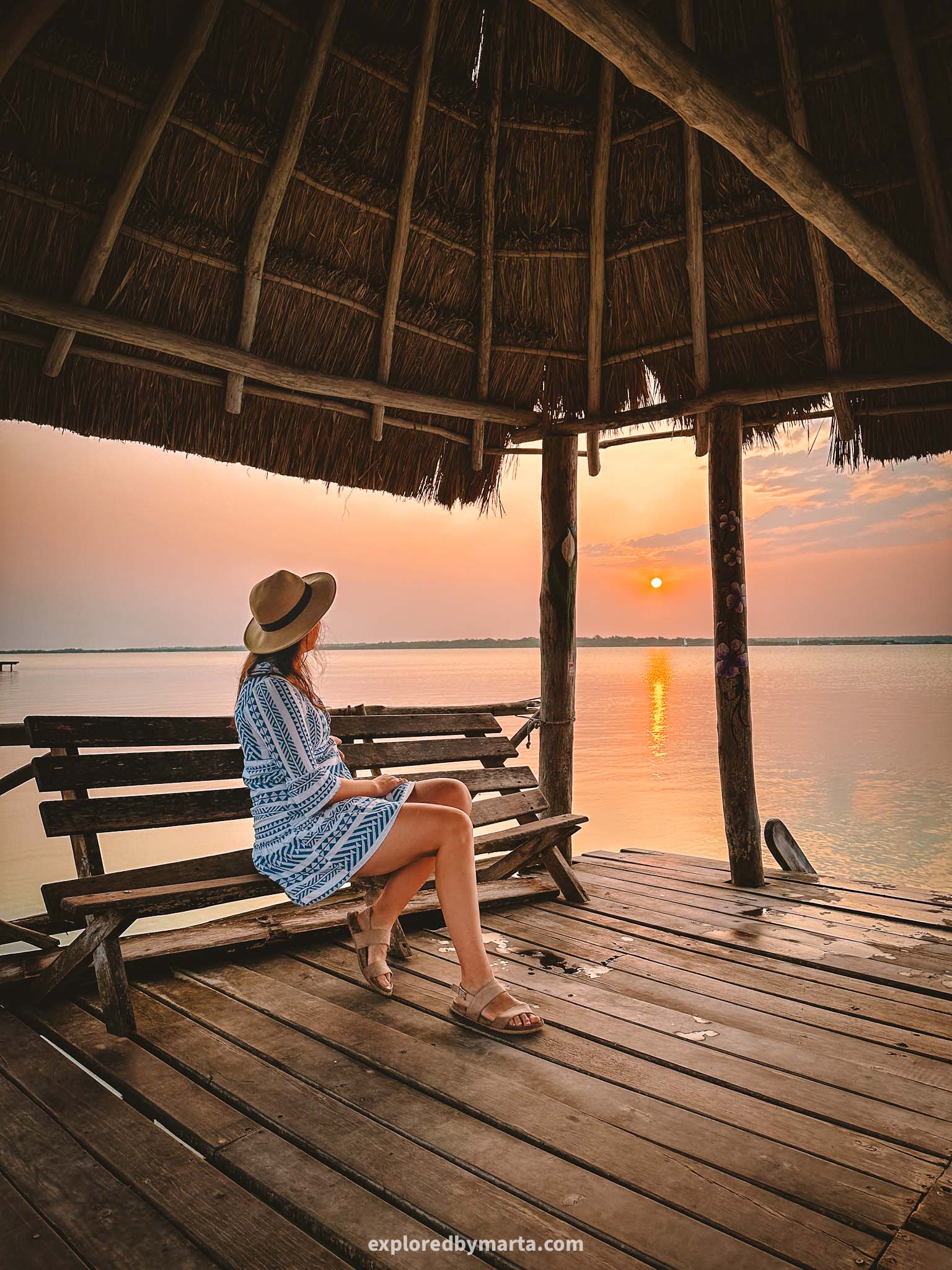 Bacalar, Mexico-sunrise over the Lagoon of Seven Colors seen from a charming wooden deck