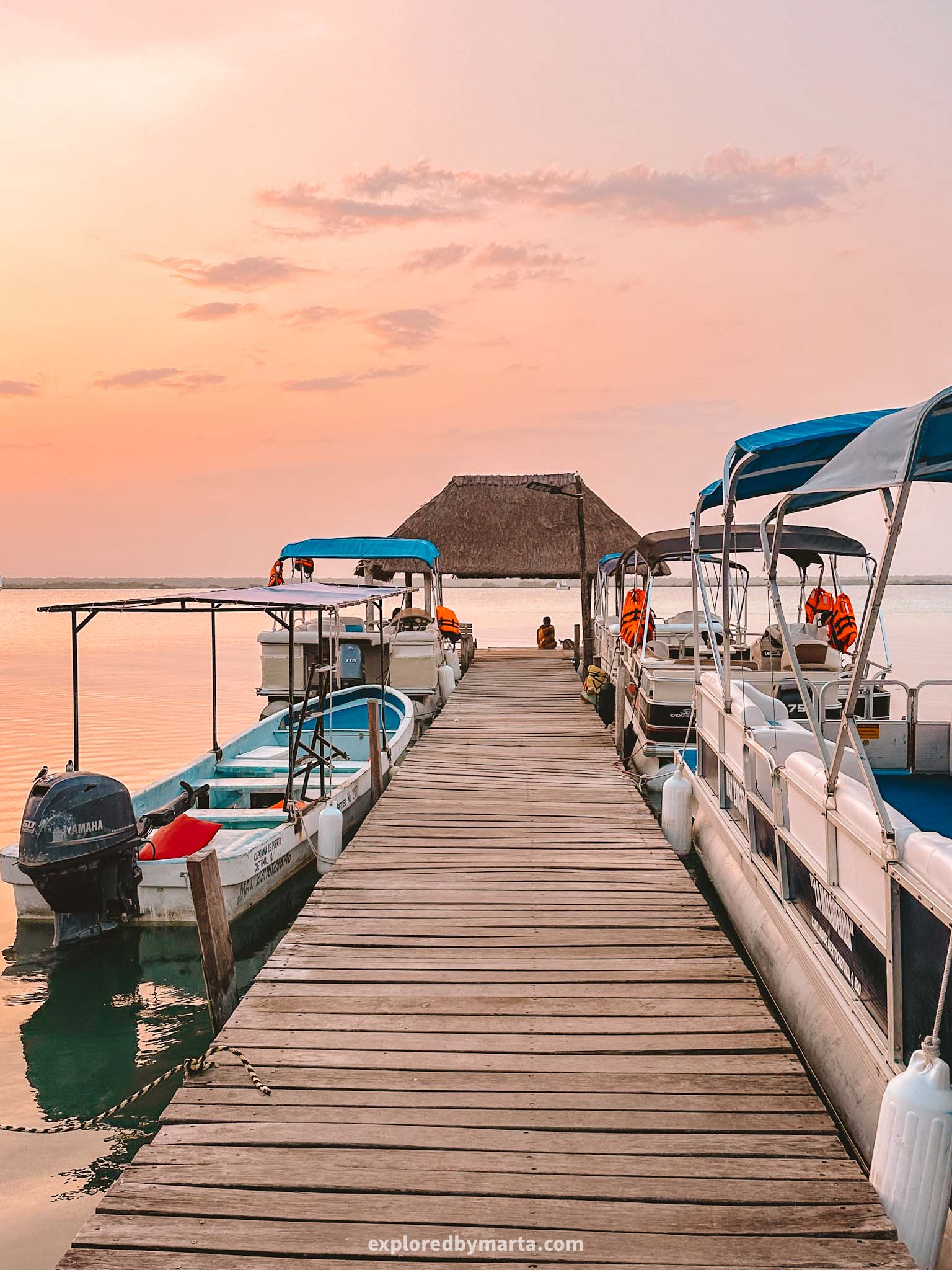 Bacalar, Mexico-sunrise over the Lagoon of Seven Colors seen from a charming wooden deck