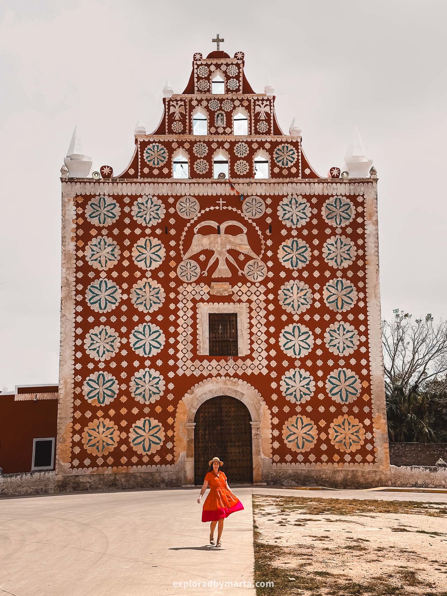 Iglesia de Uayma church is a red colored church with large white roses in Uayma town in the Yucatan Peninsula, Mexico also known as ex-convent of Santo Domingo
