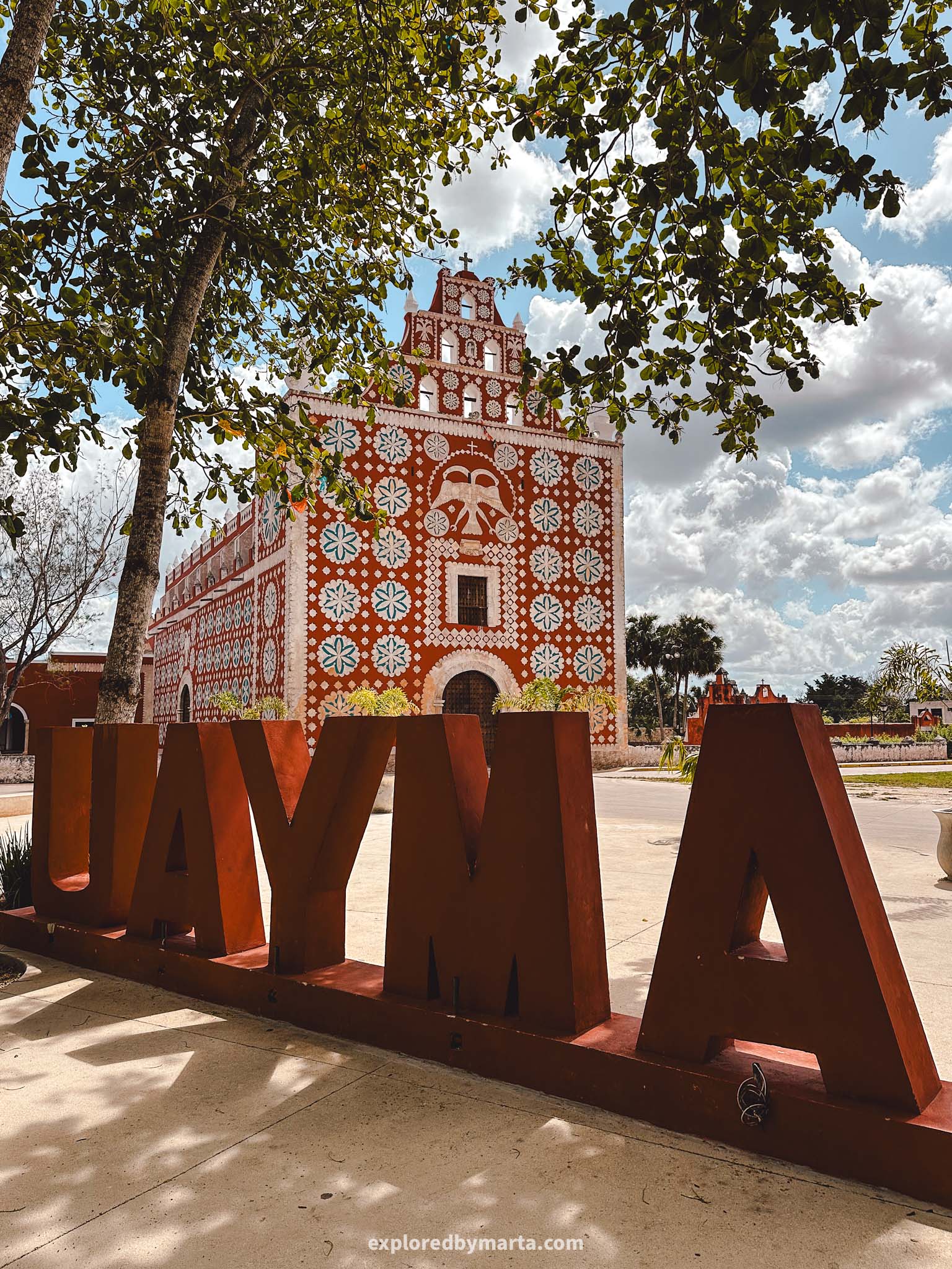 Iglesia de Uayma church is a red colored church with large white roses in Uayma town in the Yucatan Peninsula, Mexico also known as ex-convent of Santo Domingo