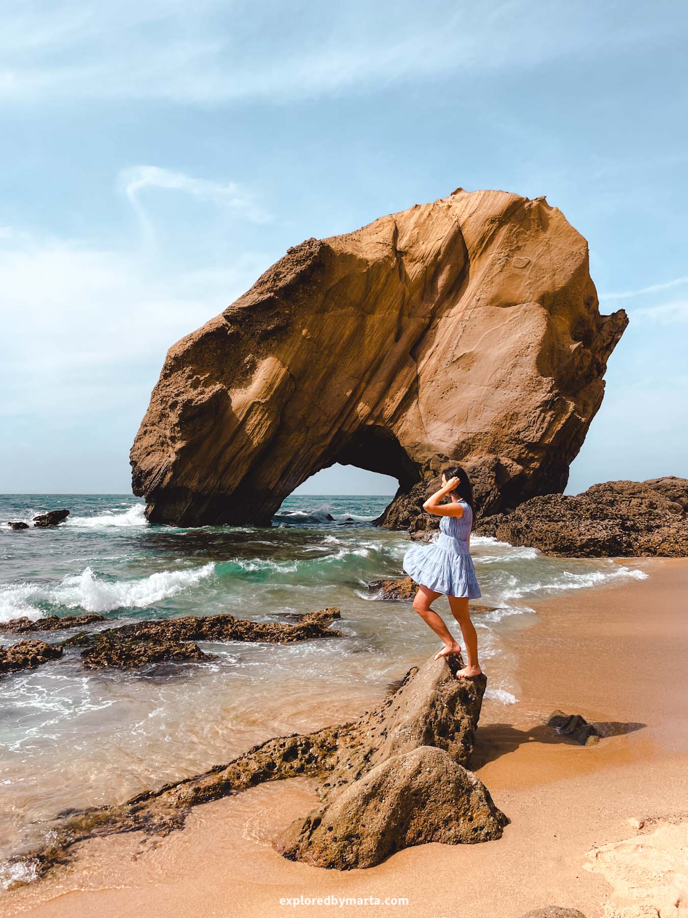 Portugal-Praia do Penedo do Guincho beach with a rock arch in Portugal