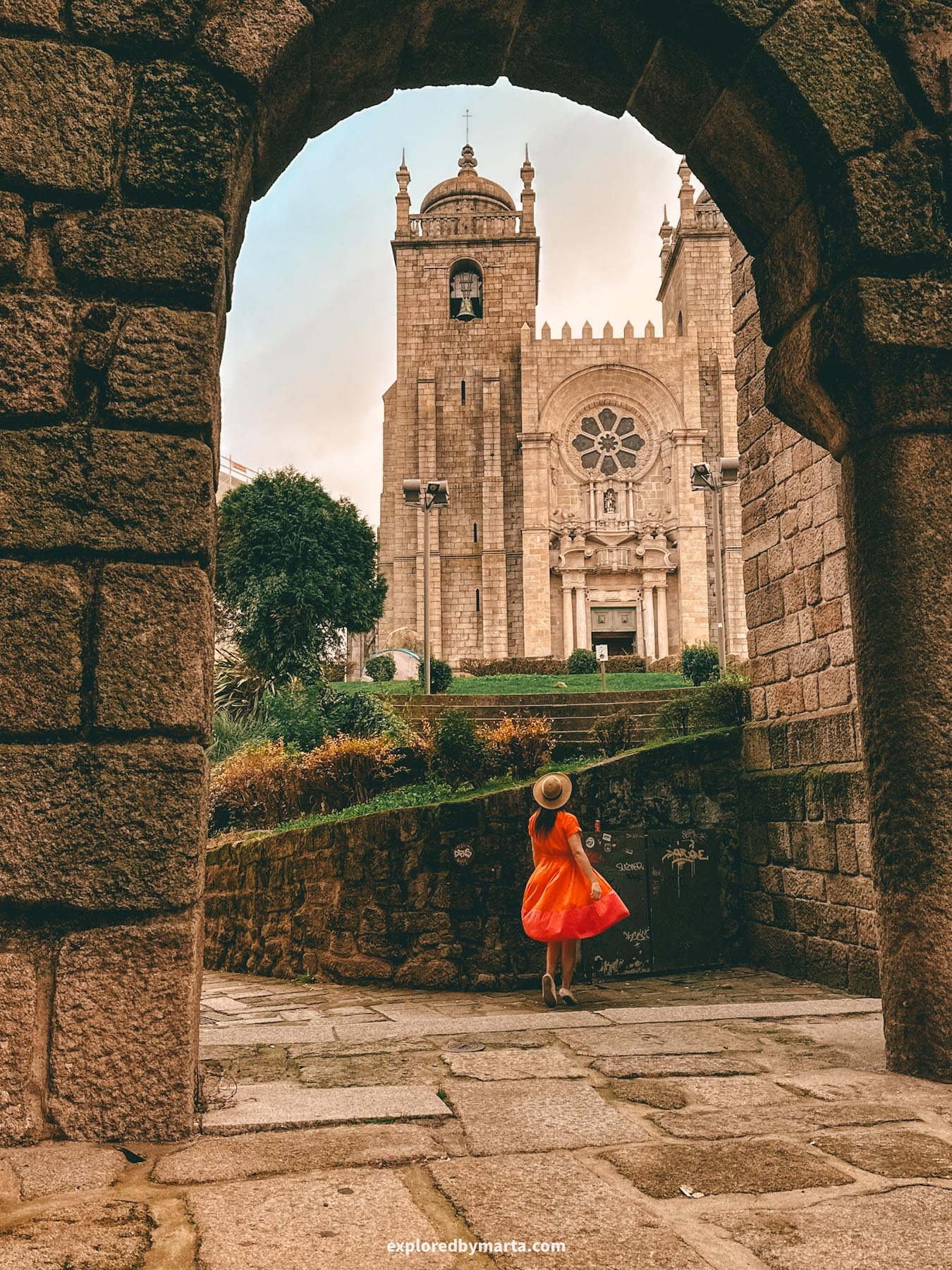 View of Porto Cathedral through a stone arch in Porto, Portugal