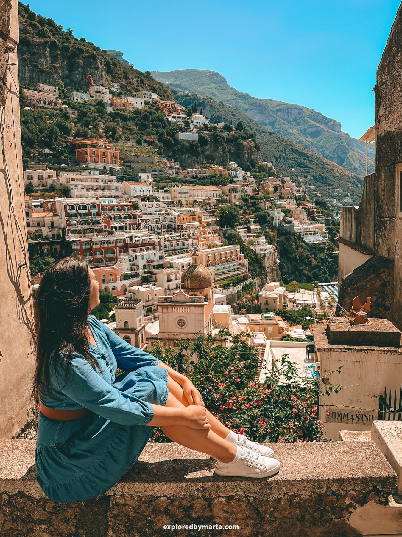 View of Positano and the iconic dome of Chiesa di Santa Maria Assunta in Positano, Italy