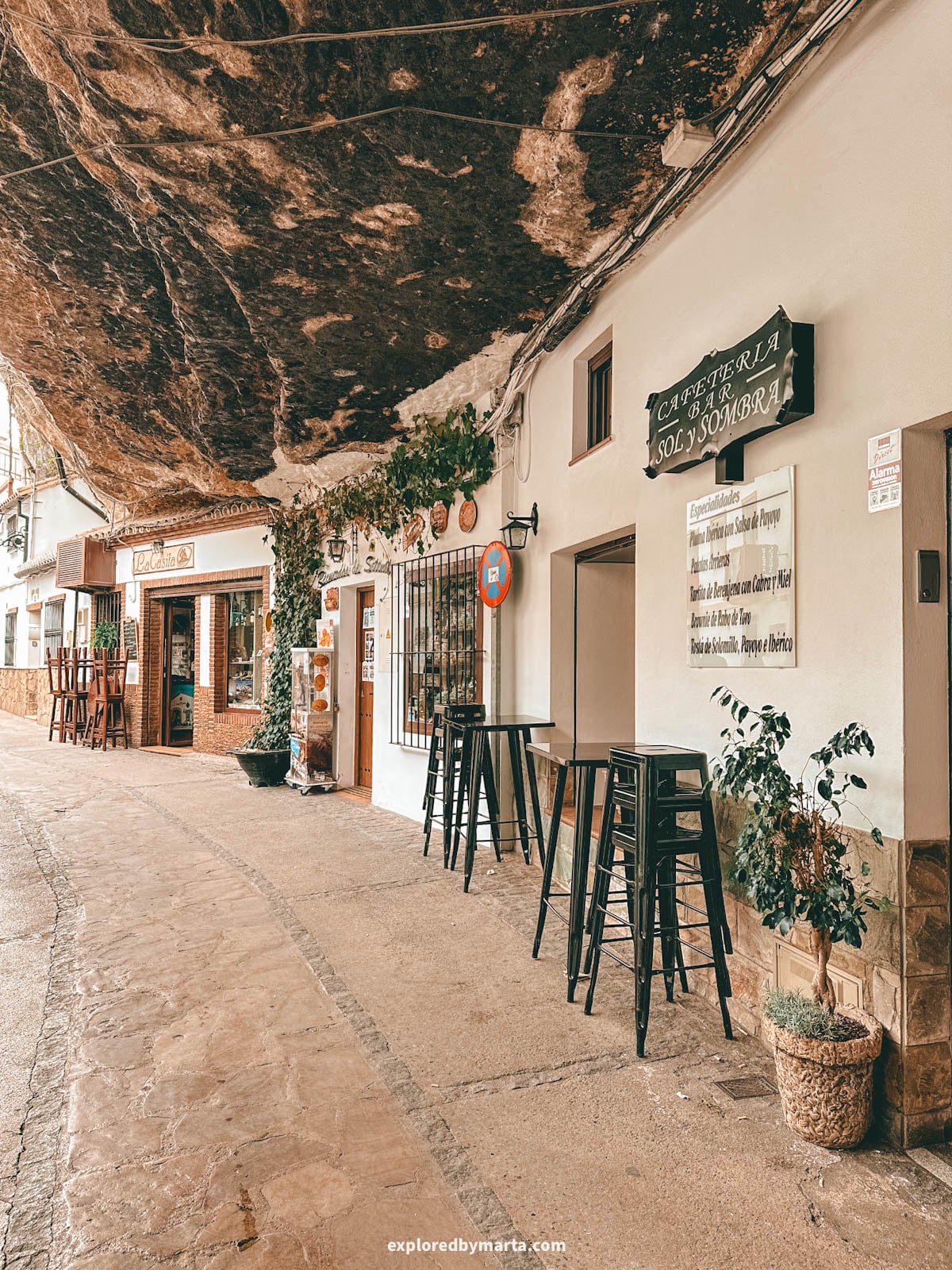 Cafes, shops and bars on Calle Cuevas de la Sombra in Setenil de las Bodegas cave village in Spain