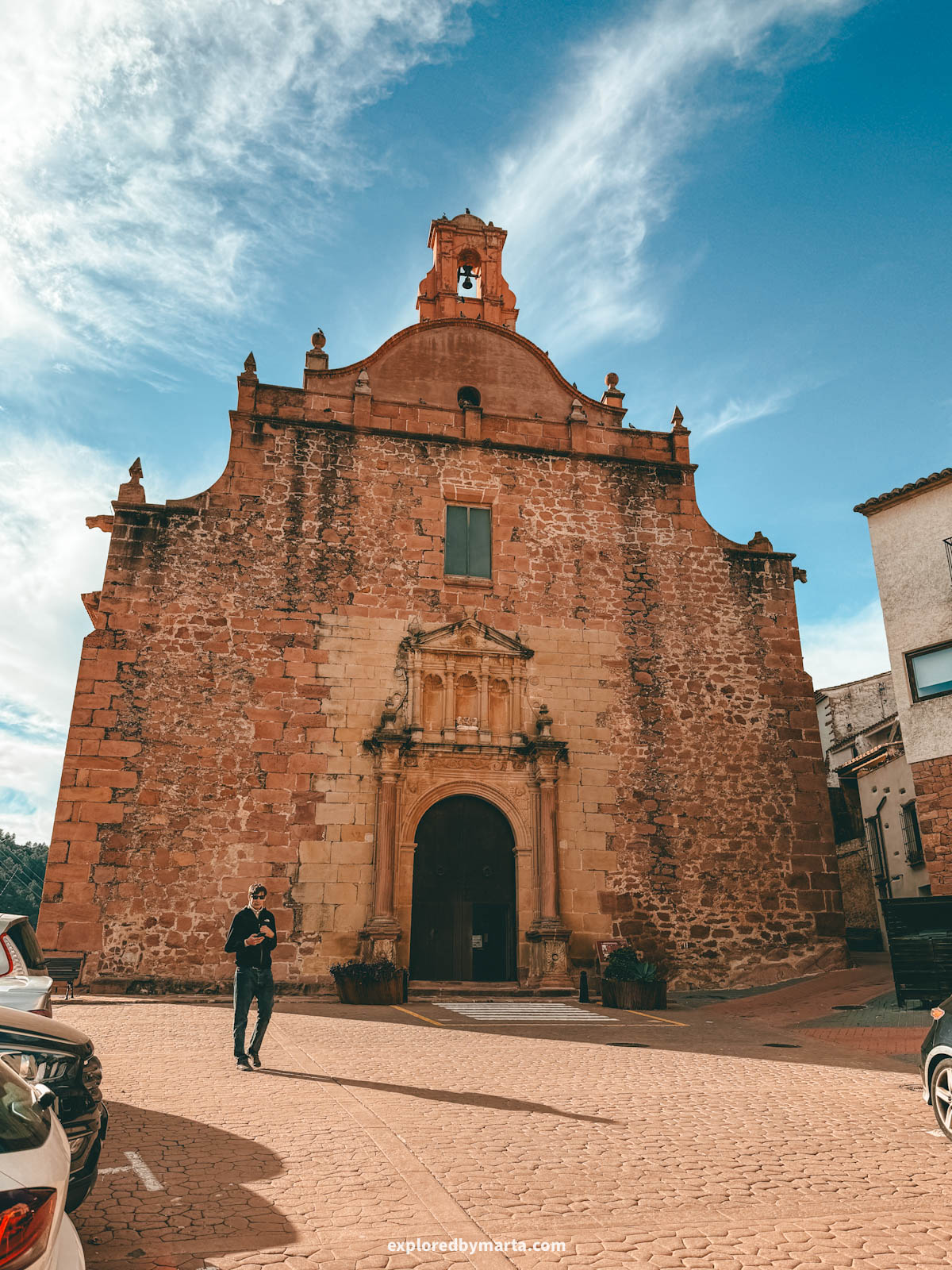 Iglesia de la Asunción de Santa María in Vilafamés, Spain with stone facade and bell tower
