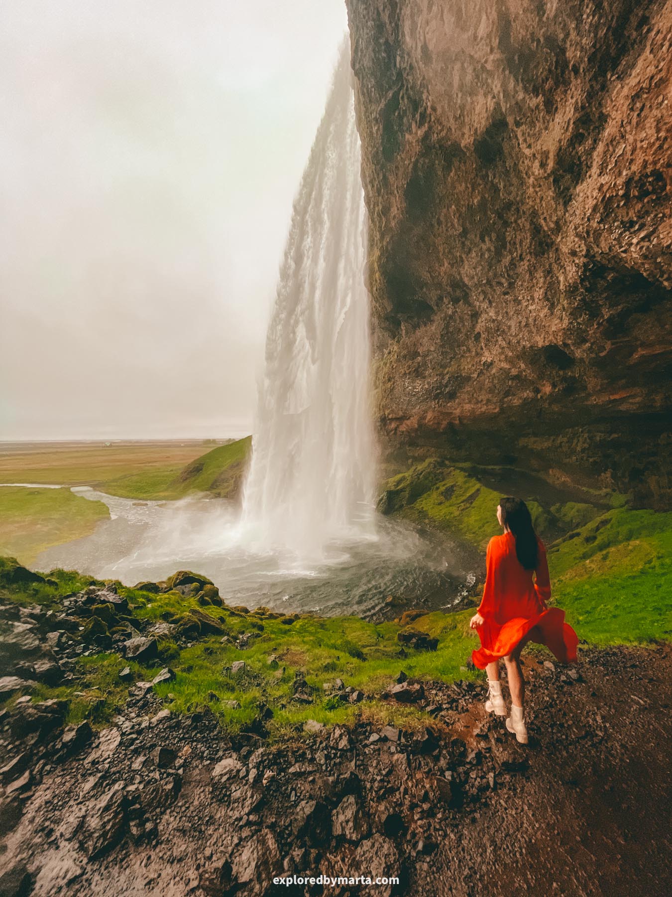 Seljalandsfoss Waterfall in Iceland has a path to walk behind it and come out the other side of the waterfall