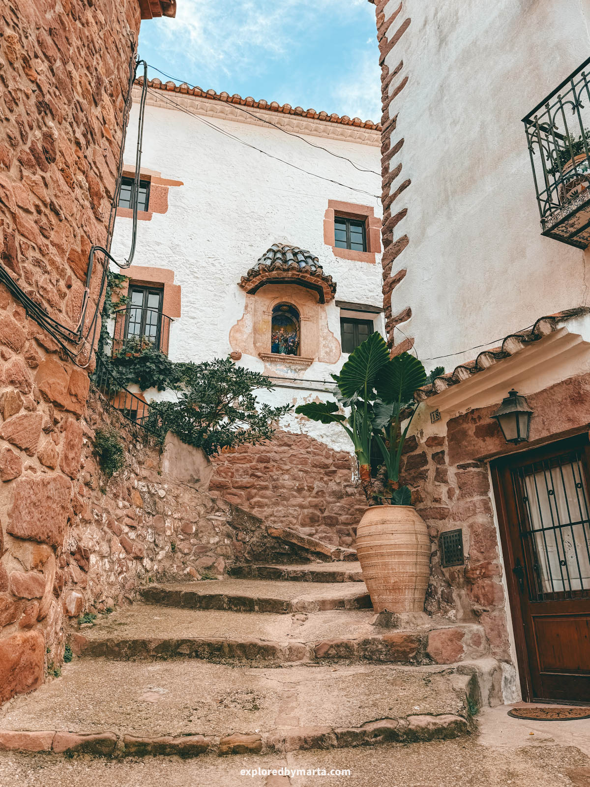 The most charming streets with flower pots and stone architecture in the historical neighbourhood of El Quartillo in Vilafamés, Valencia Region, Spain