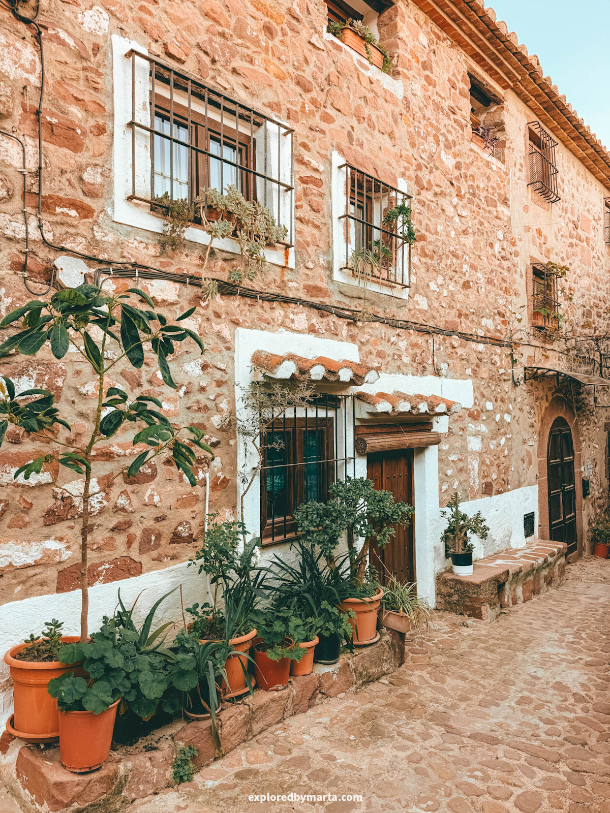 The most charming streets with flower pots and stone architecture in the historical neighbourhood of El Quartillo in Vilafamés, Valencia Region, Spain