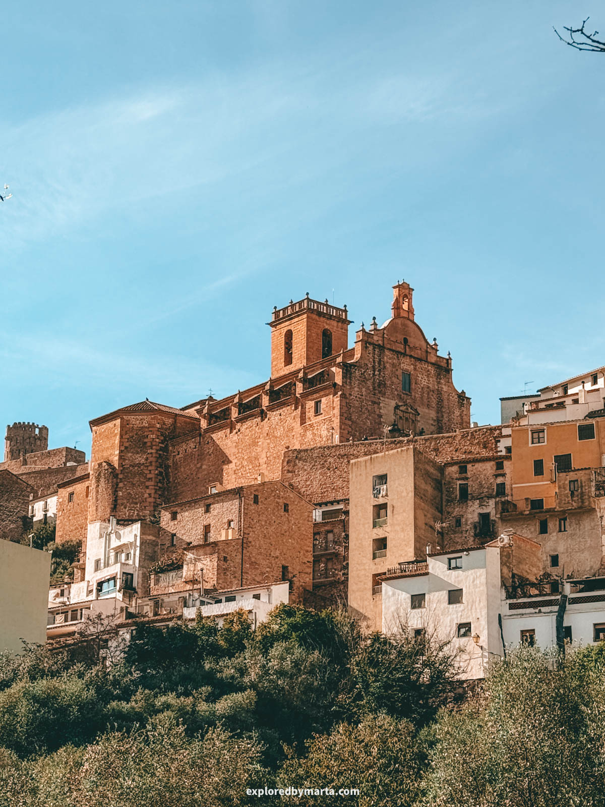 View of castle and church rising above the village in Vilafamés, Valencia Region, Spain