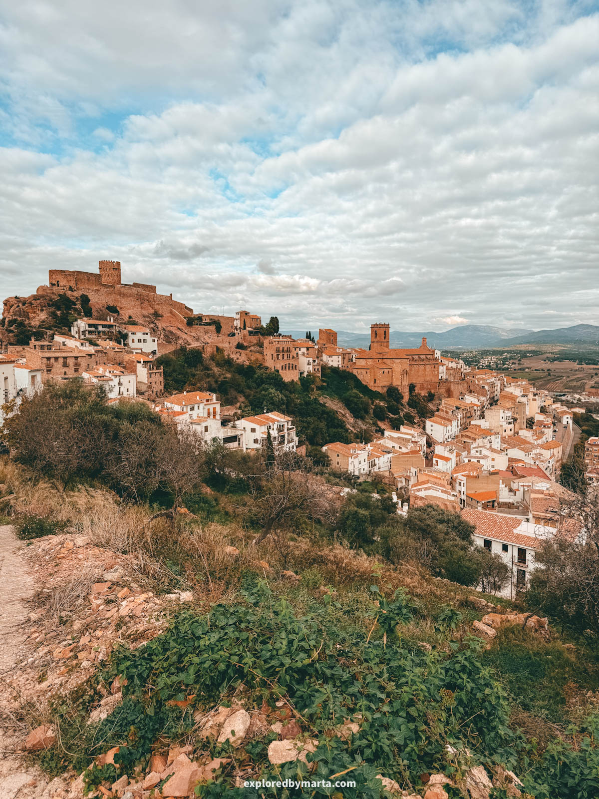 View of castle and church sitting above the village in Vilafamés, Valencia Region, Spain