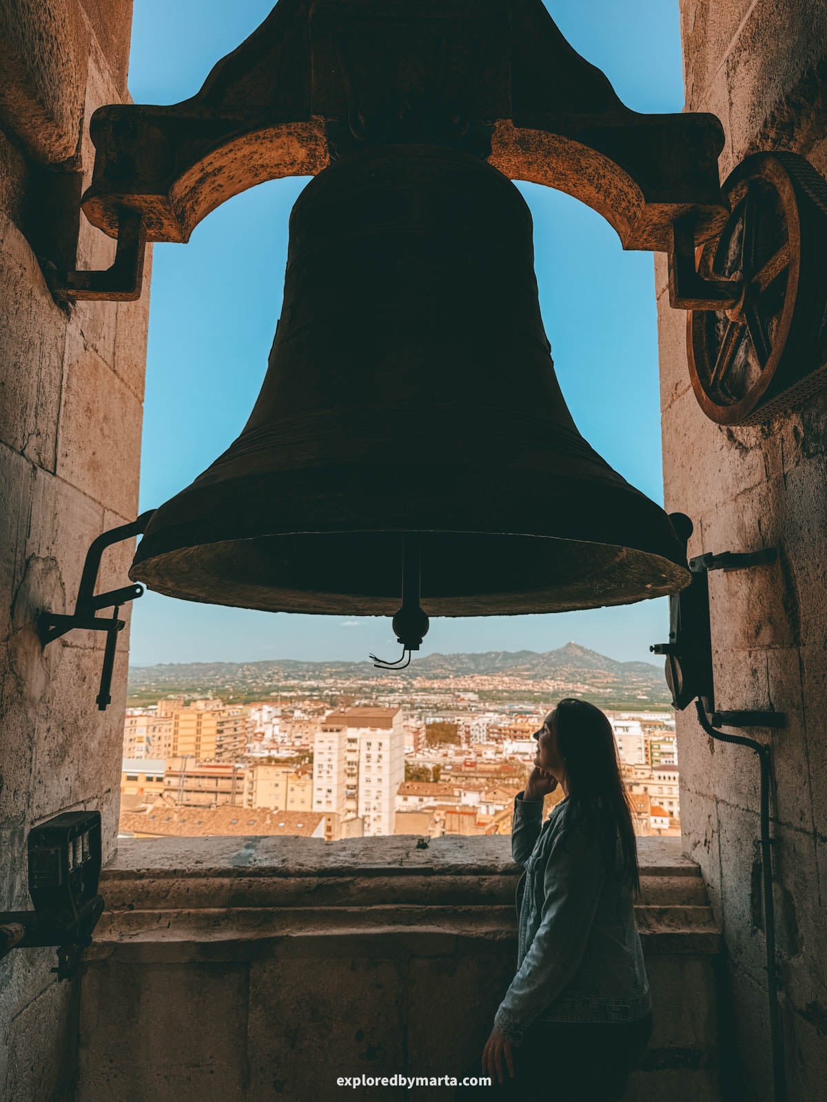 Admiring views over the old town when visiting the 69-meter bell tower of the Collegiate Basilica of Xàtiva, also known as La Seu, in Xativa, Spain