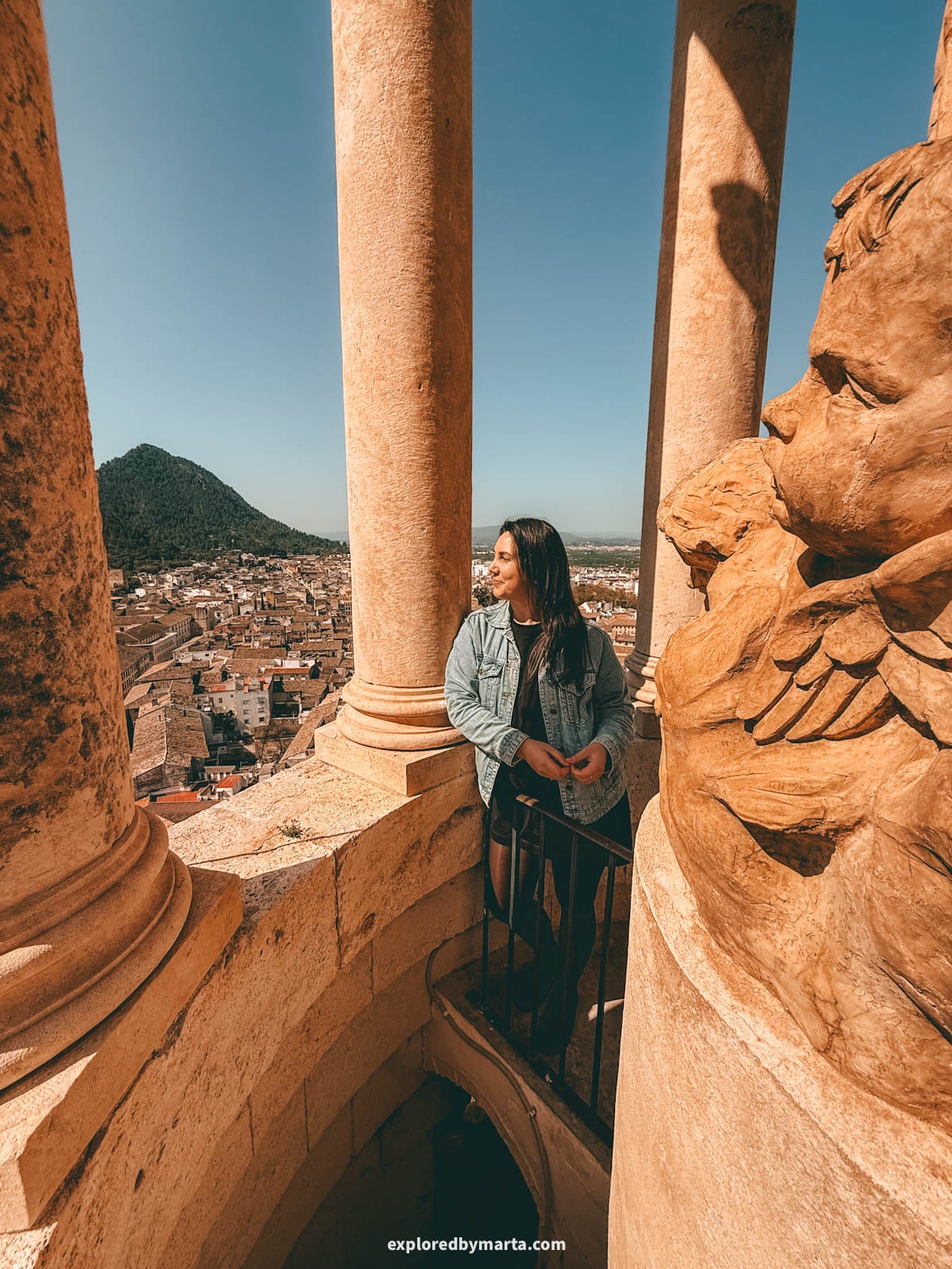 Admiring views over the old town when visiting the 69-meter bell tower of the Collegiate Basilica of Xàtiva, also known as La Seu, in Xativa, Spain