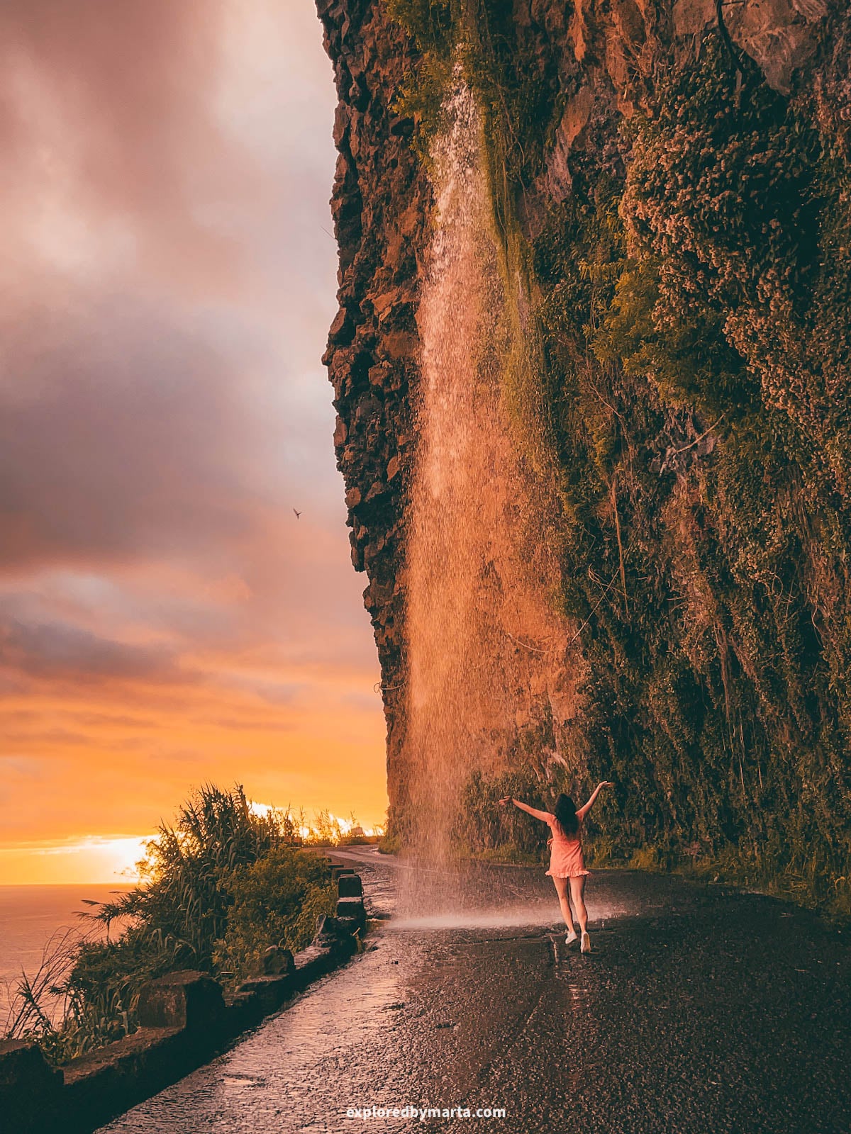 Cascata dos Anjos (Angels Waterfall) falling on a coastal road in Madeira, Portugal