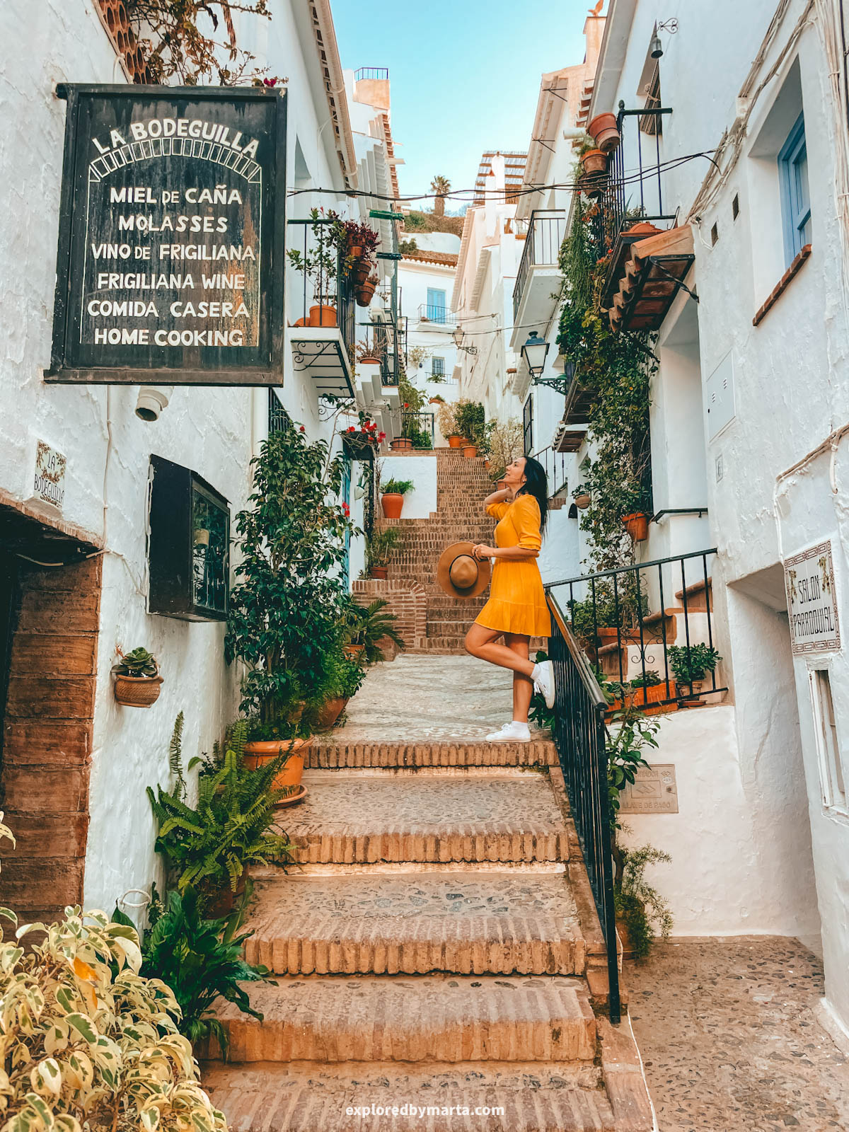 Flower-filled stairs of Calle El Garral in Frigiliana, Spain