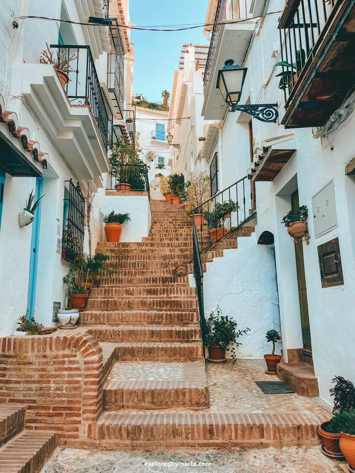 Flower-filled stairs of Calle El Garral in Frigiliana, Spain