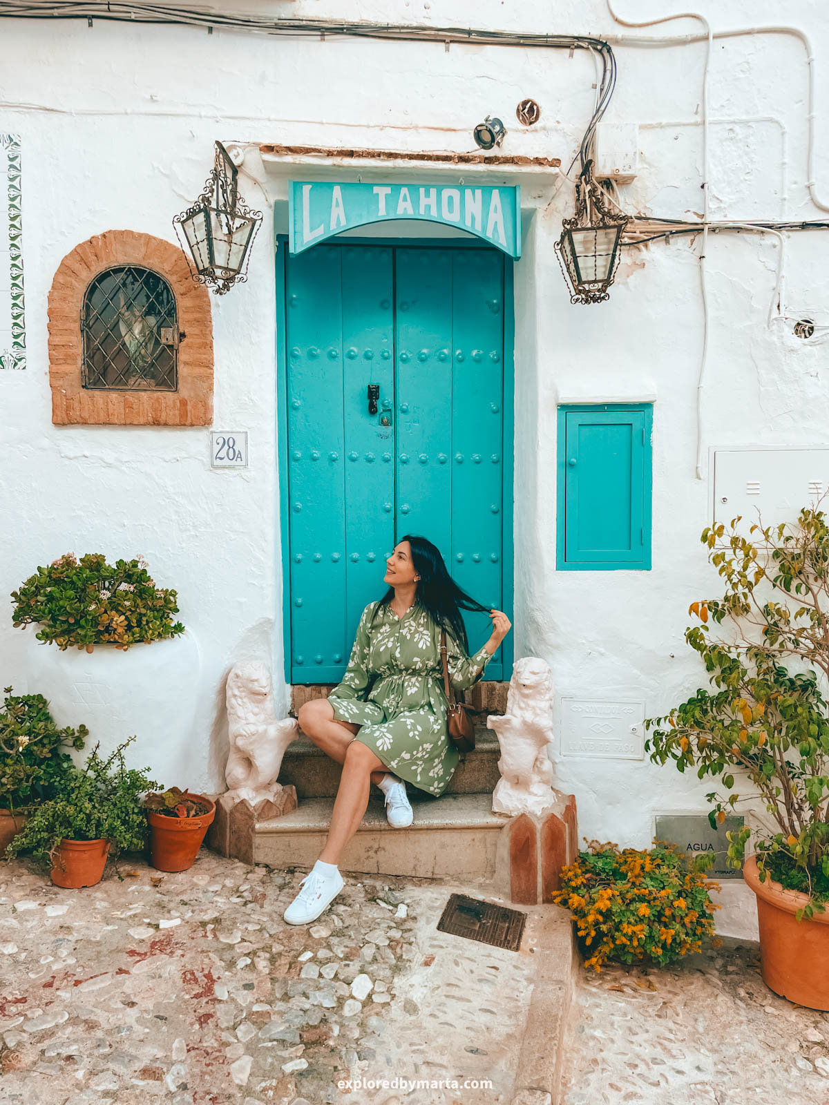 Flower-filled steps of Calle Zacatín in Frigiliana, Spain