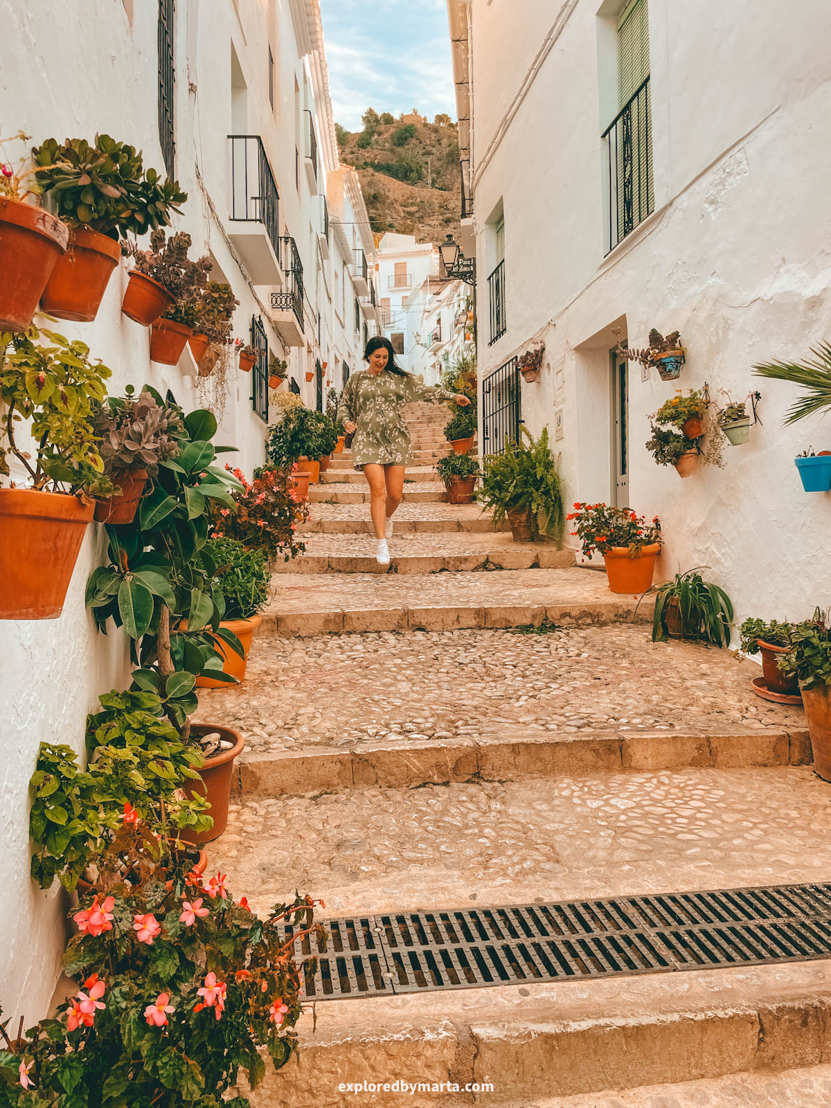 Flower-filled steps of Calle Zacatín in Frigiliana, Spain
