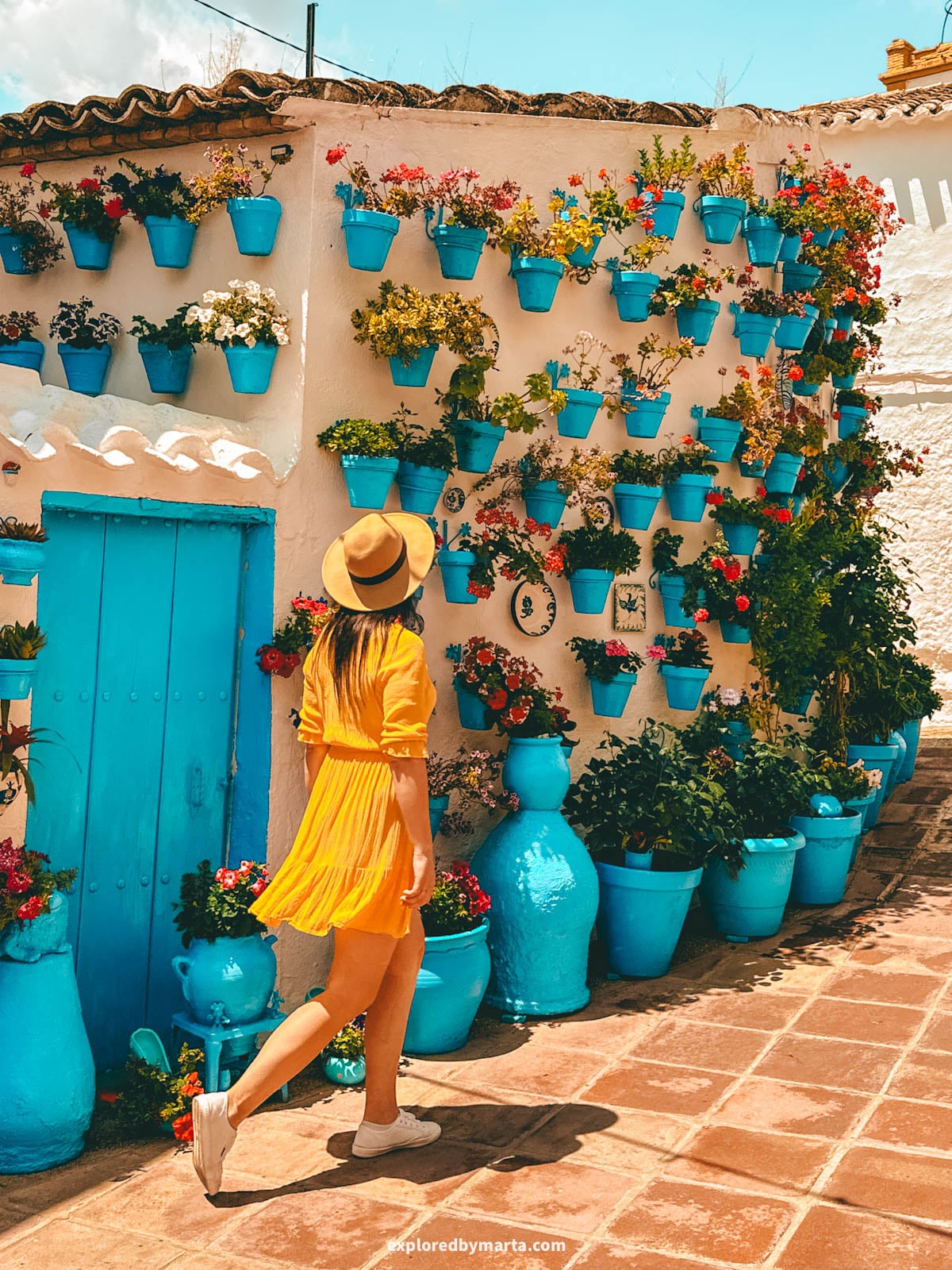 Patio de las Comedias flower courtyard with blue flower pots in Iznajar village in Cordoba Province, Southern Spain