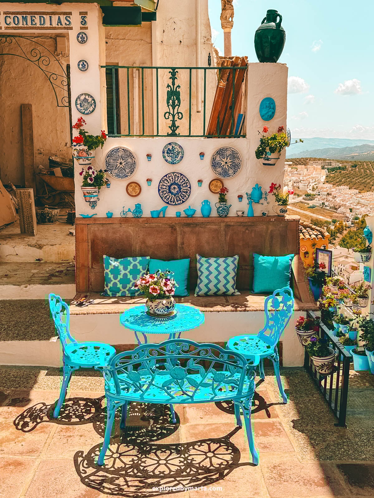 Patio de las Comedias flower courtyard with blue flower pots in Iznajar village in Cordoba Province, Southern Spain
