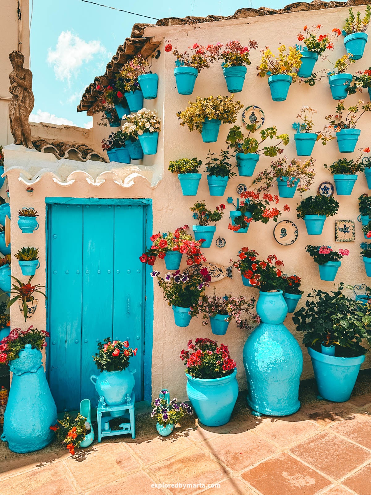 Patio de las Comedias flower courtyard with blue flower pots in Iznajar village in Cordoba Province, Southern Spain