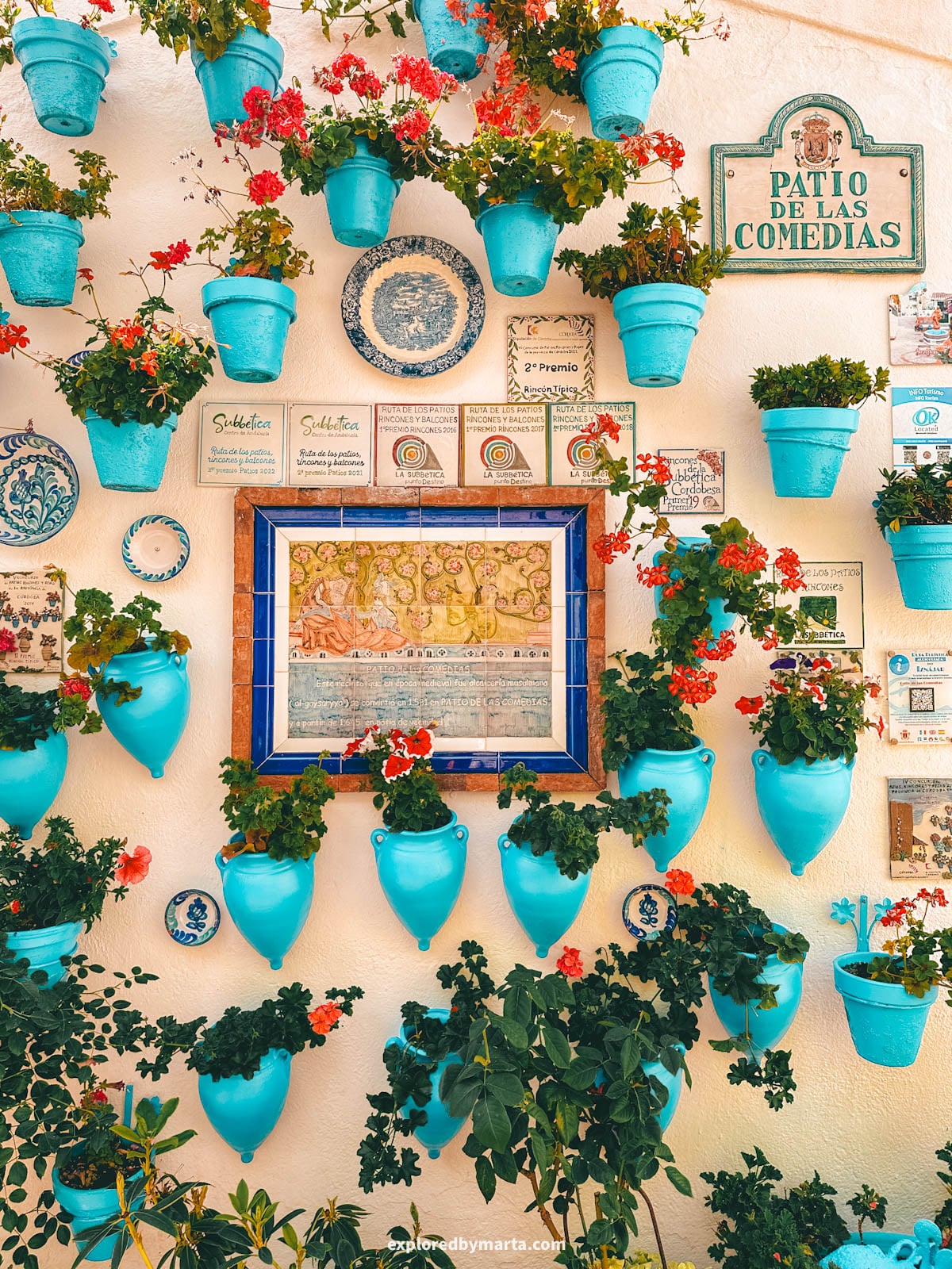 Patio de las Comedias flower courtyard with blue flower pots in Iznajar village in Cordoba Province, Southern Spain