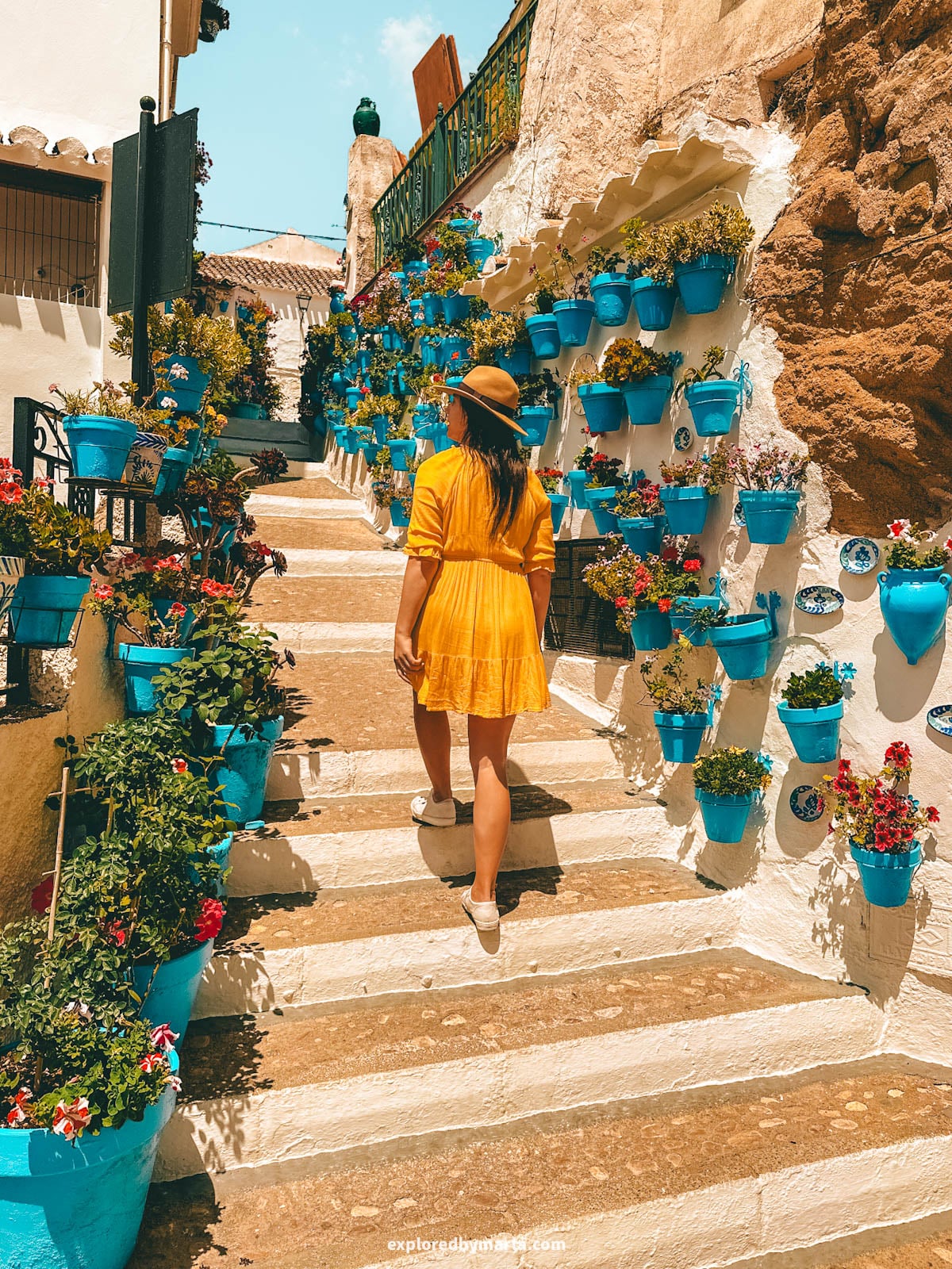 Patio de las Comedias flower courtyard with blue flower pots in Iznajar village in Cordoba Province, Southern Spain