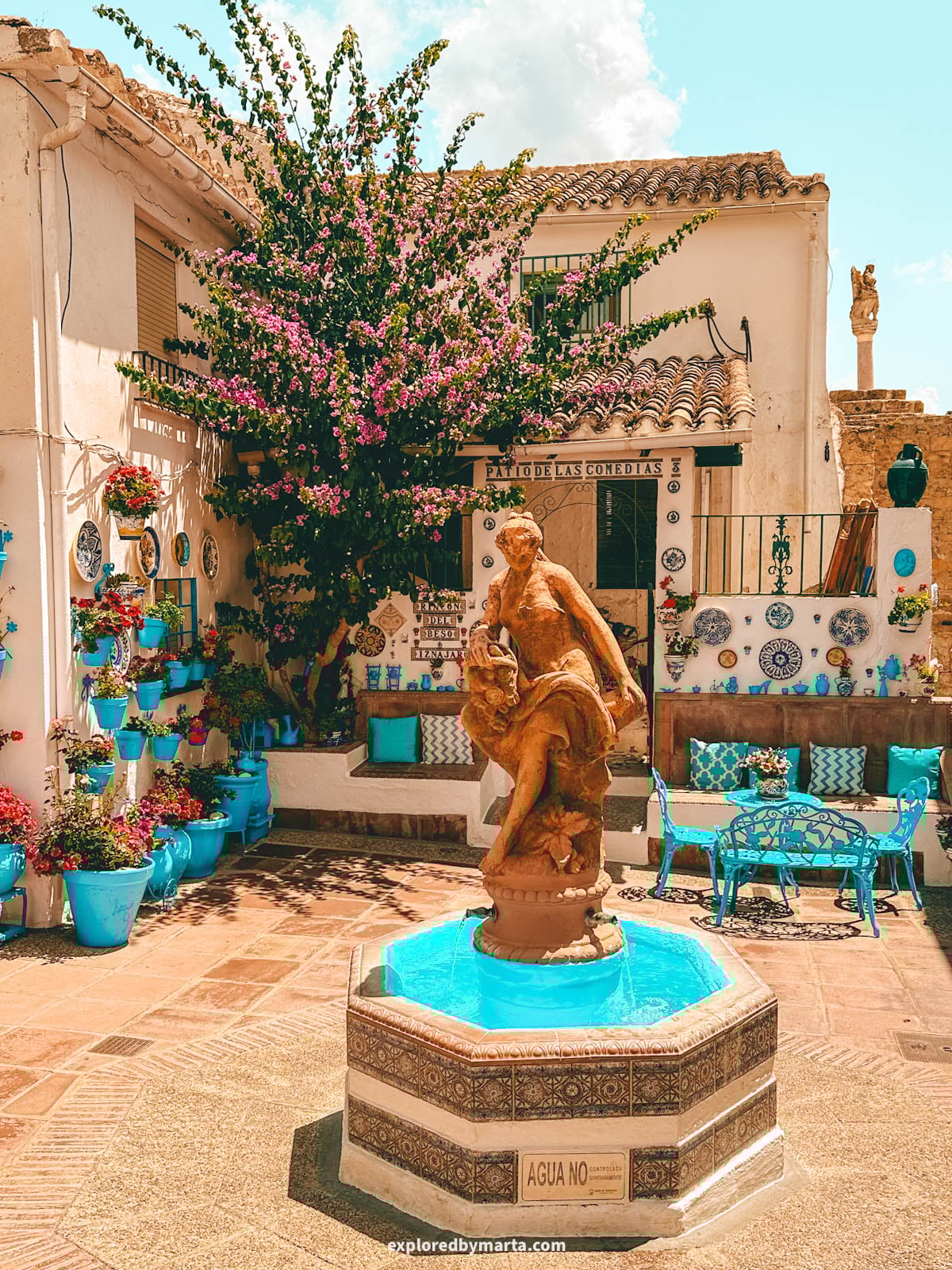 Patio de las Comedias flower courtyard with blue flower pots in Iznajar village in Cordoba Province, Southern Spain