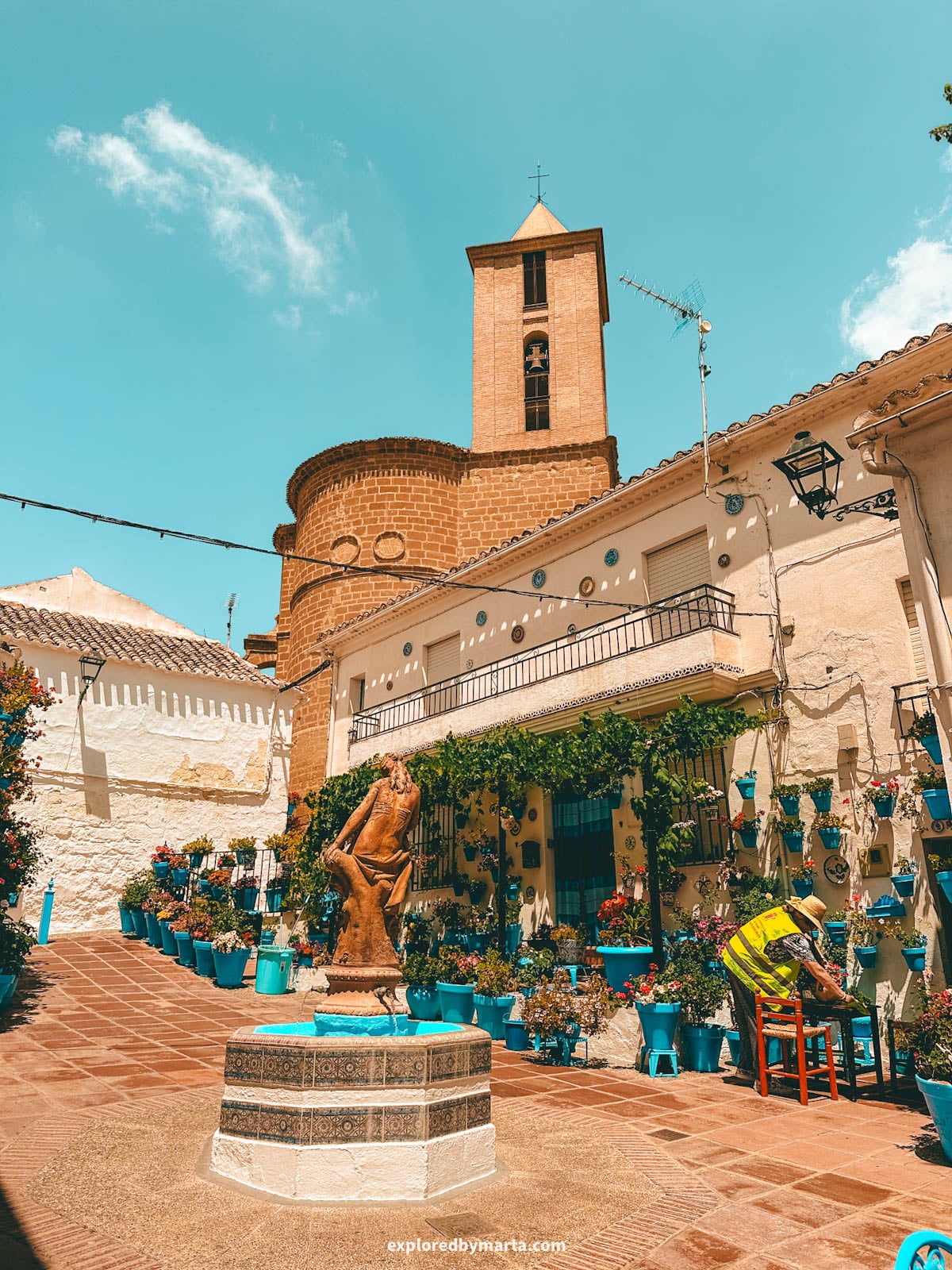 Patio de las Comedias flower courtyard with blue flower pots in Iznajar village in Cordoba Province, Southern Spain