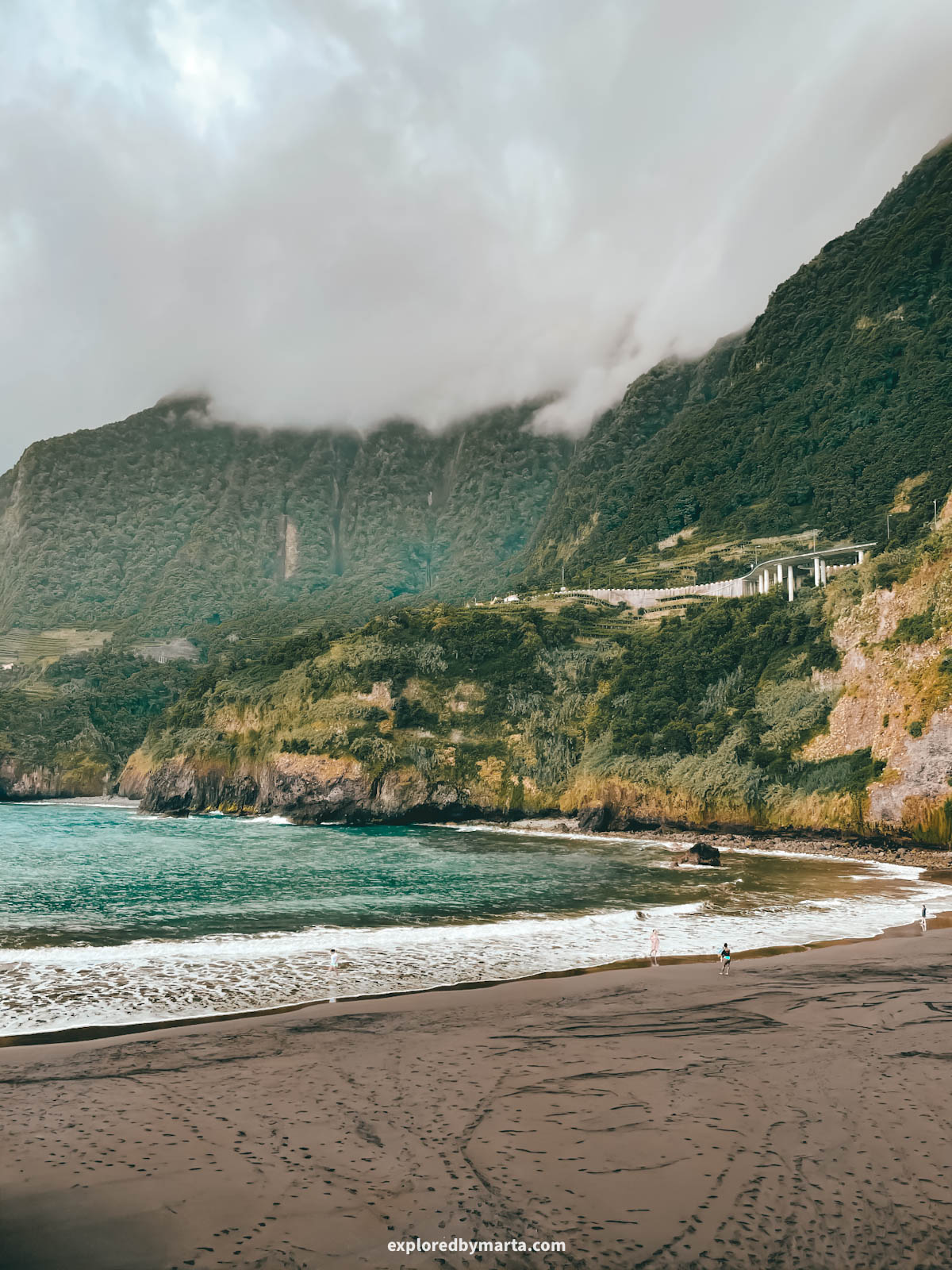 Seixal black sand beach Praia do Porto do Seixal with dramatic cliffs and waterfalls in Madeira, Portugal