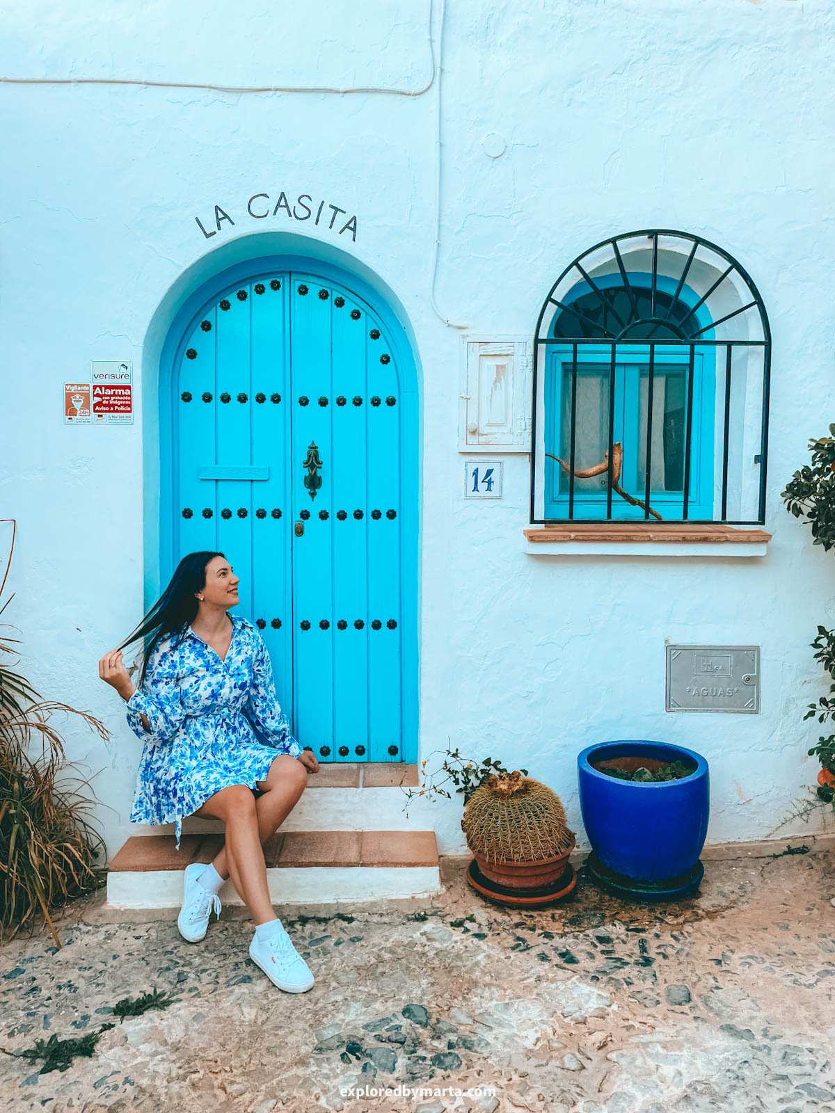 The blue La Casita doors with the arched window in Frigiliana, Spain