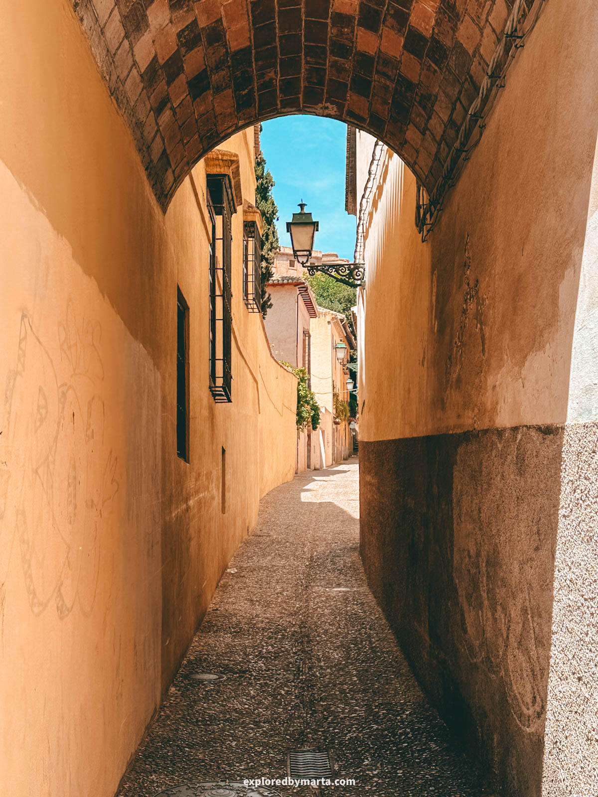 Archway over a sidestreet on Carrera del Darro in Granada, Spain