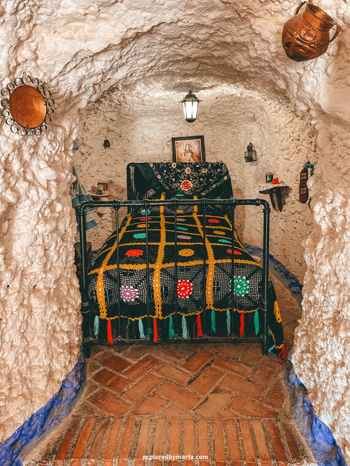 Visiting bedroom inside Museo Cuevas del Sacromonte in Granada, Spain