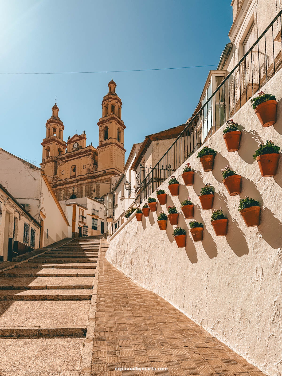 Calle Calzada climbing up toward the church in Olvera, Andalusia, Spain