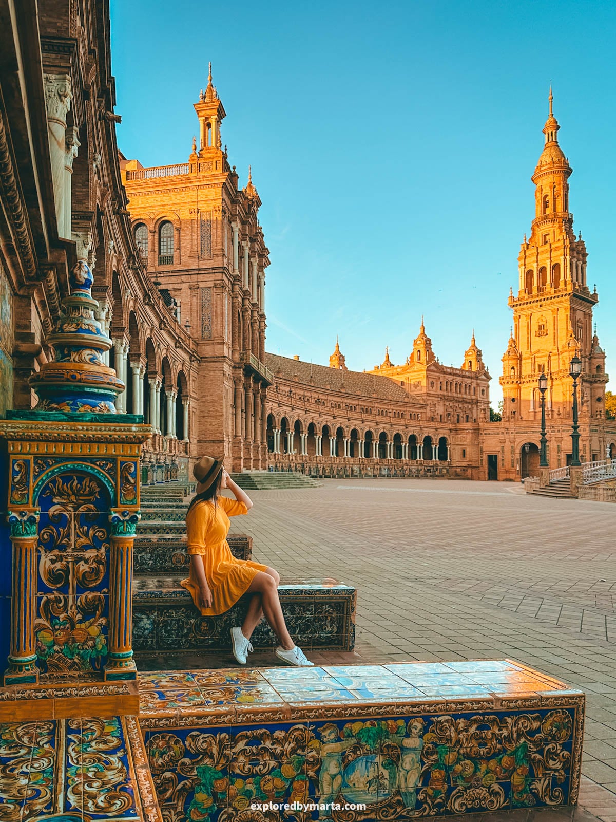 Colorful tiled steps with the tower behind at Plaza de España in Seville, Spain