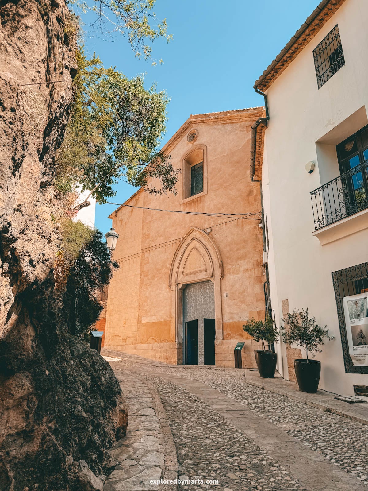 Facade of the church in Guadalest with its pointed Gothic doorway in Spain