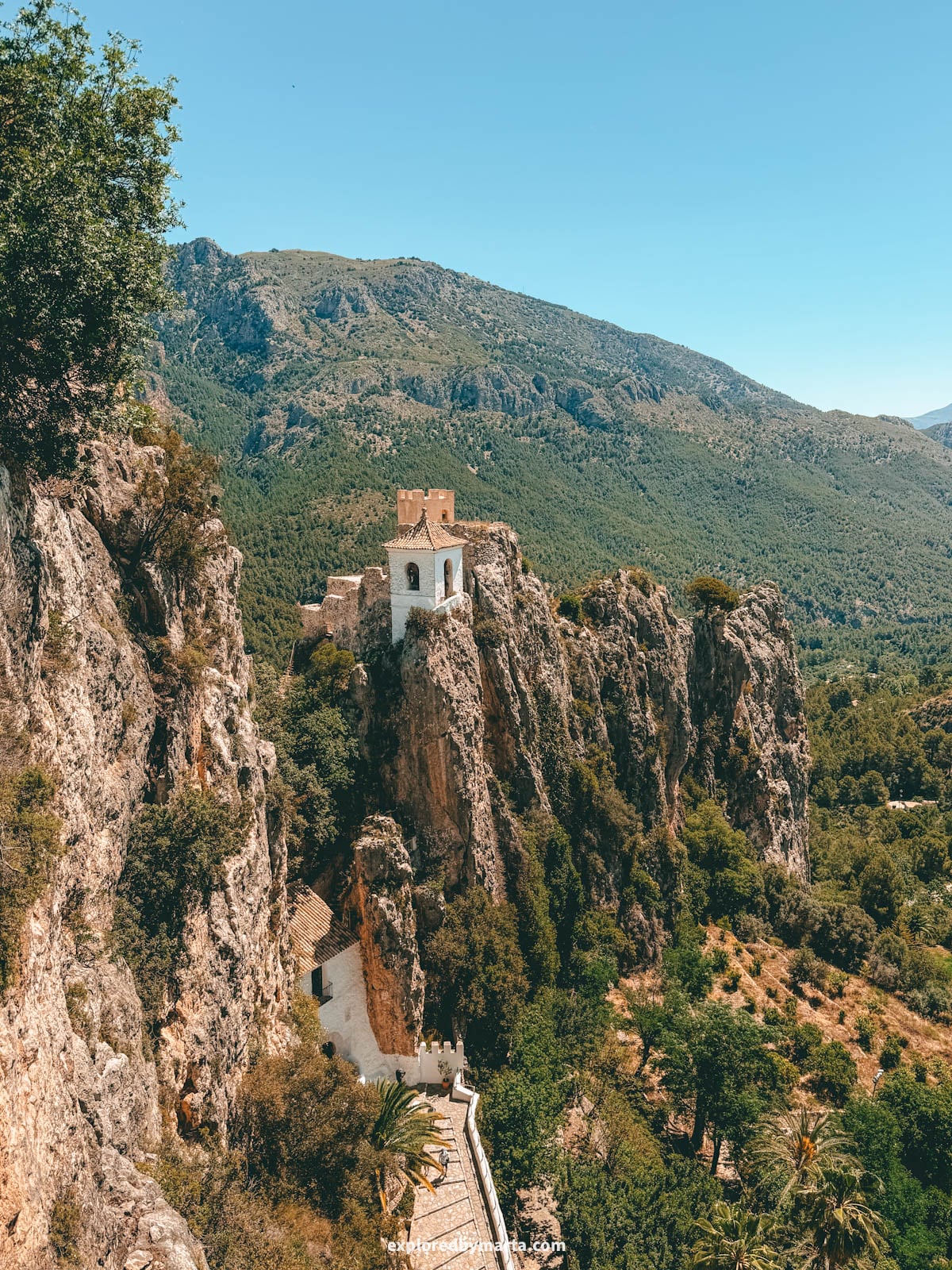 Guadalest bell tower on the rocky crag seen from the cemetery viewpoint in Valencia Region, Spain