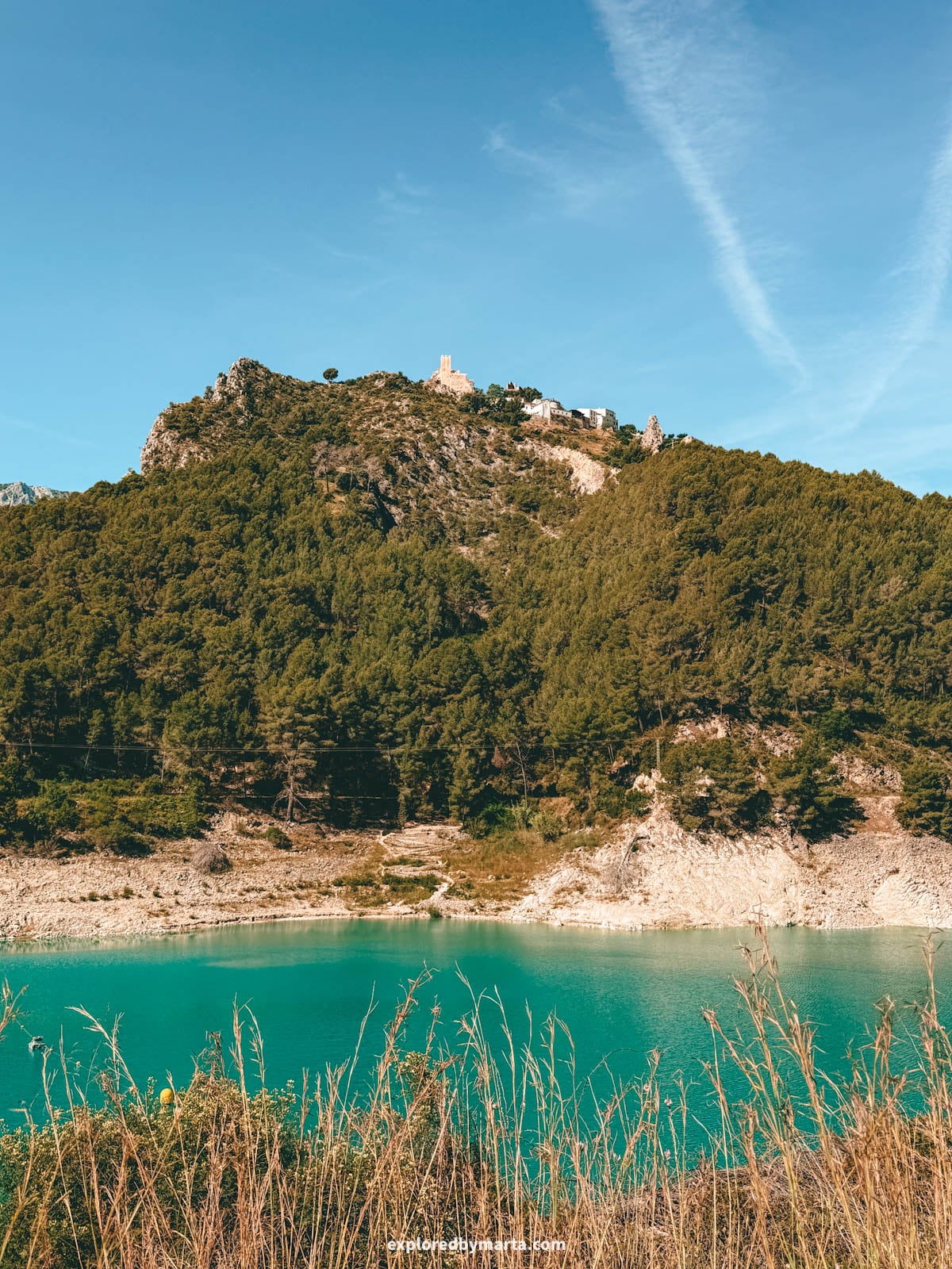 Hiking around the turquoise Guadalest reservoir in Valencia Region, Spain