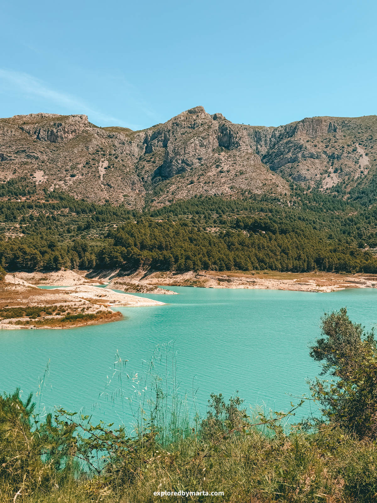 Hiking around the turquoise Guadalest reservoir in Valencia Region, Spain