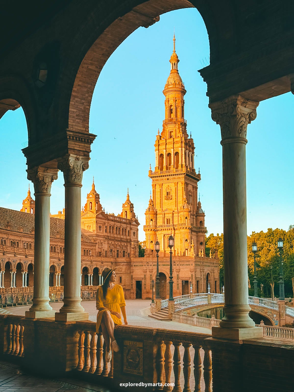 Plaza de España tower framed through the arches in Seville, Spain