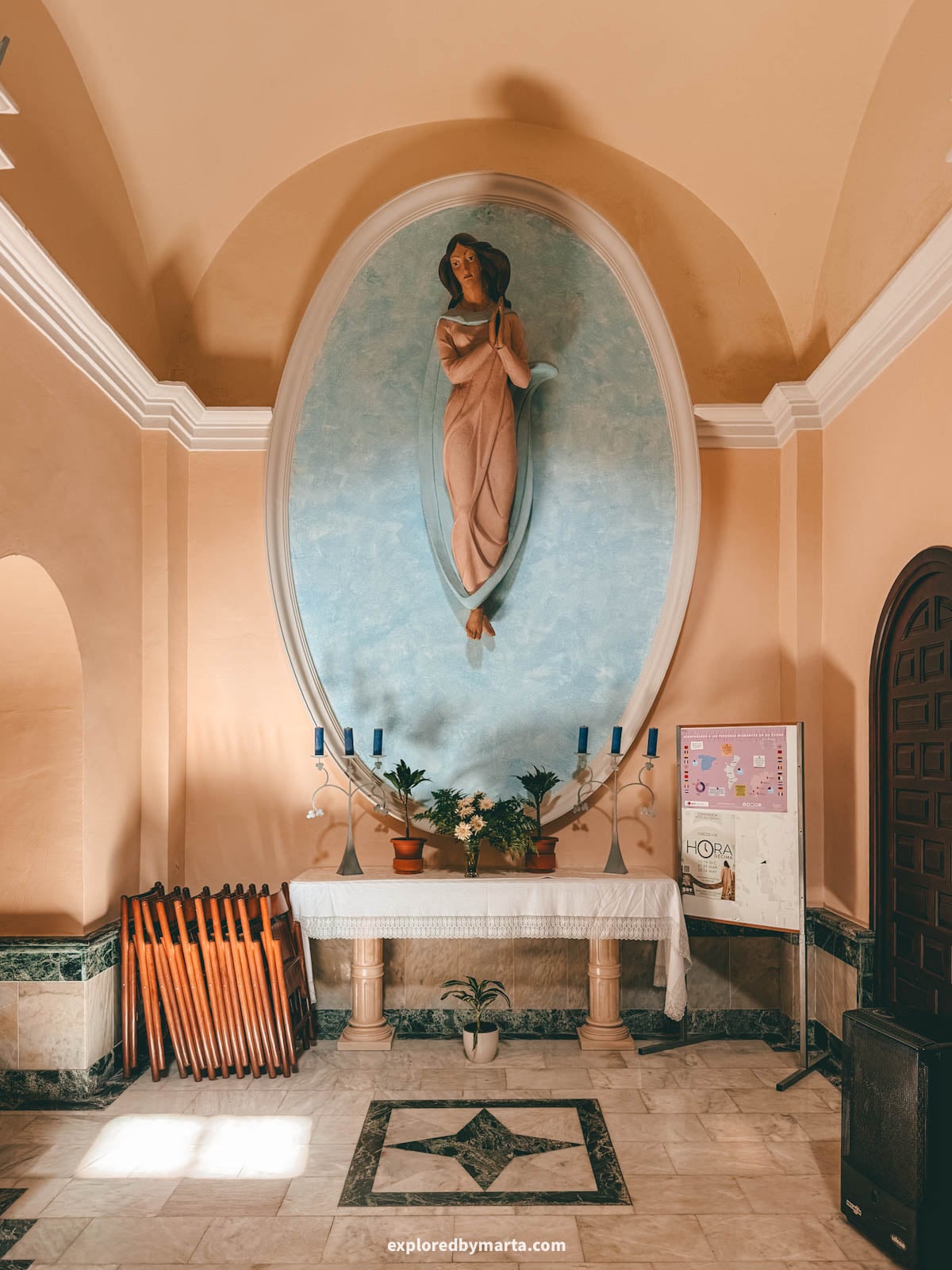 Statue of the Virgin in an oval niche inside the church in Guadalest, Spain