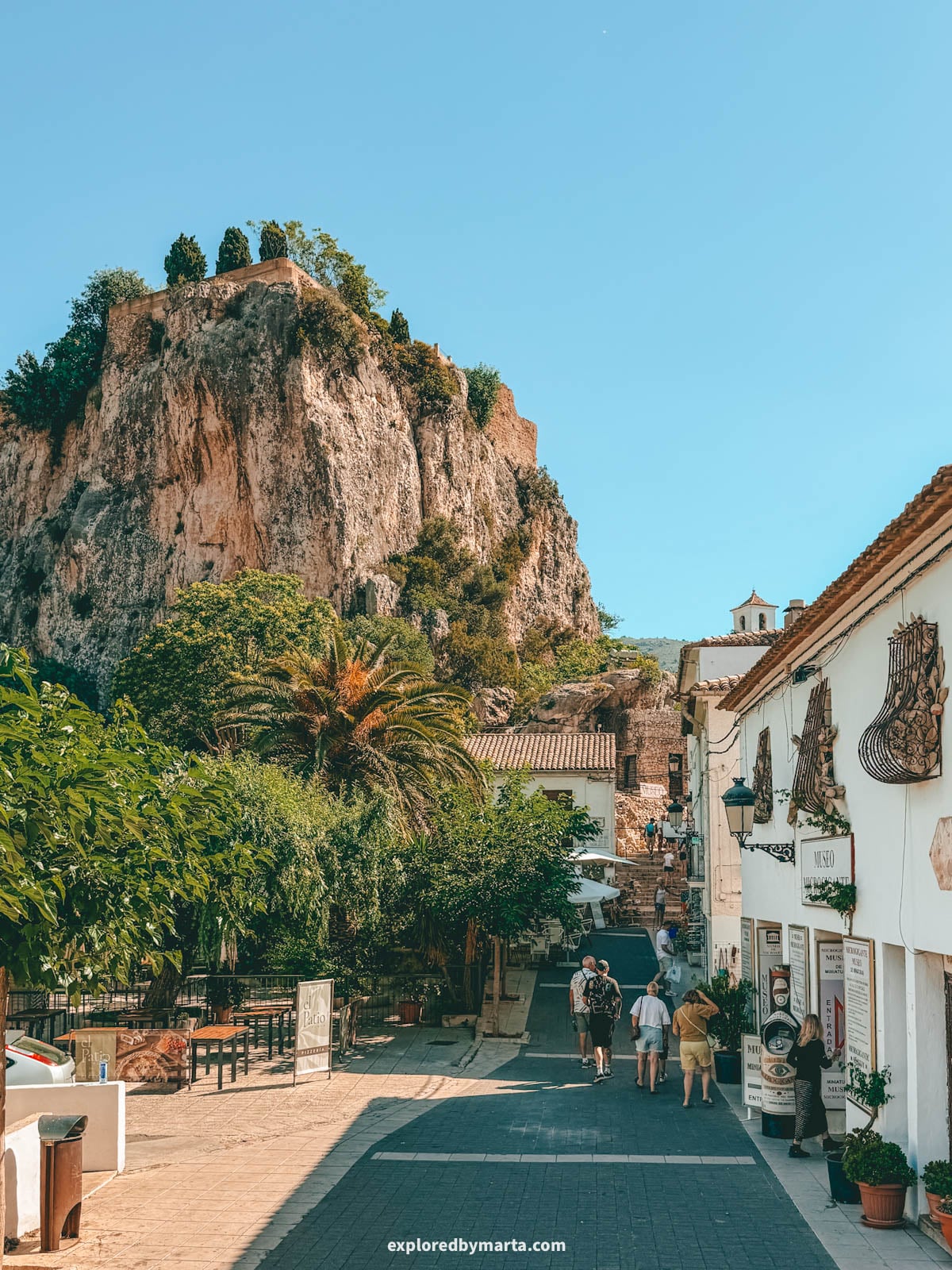 Street leading up to the old town below the castle rock in Guadalest, Spain
