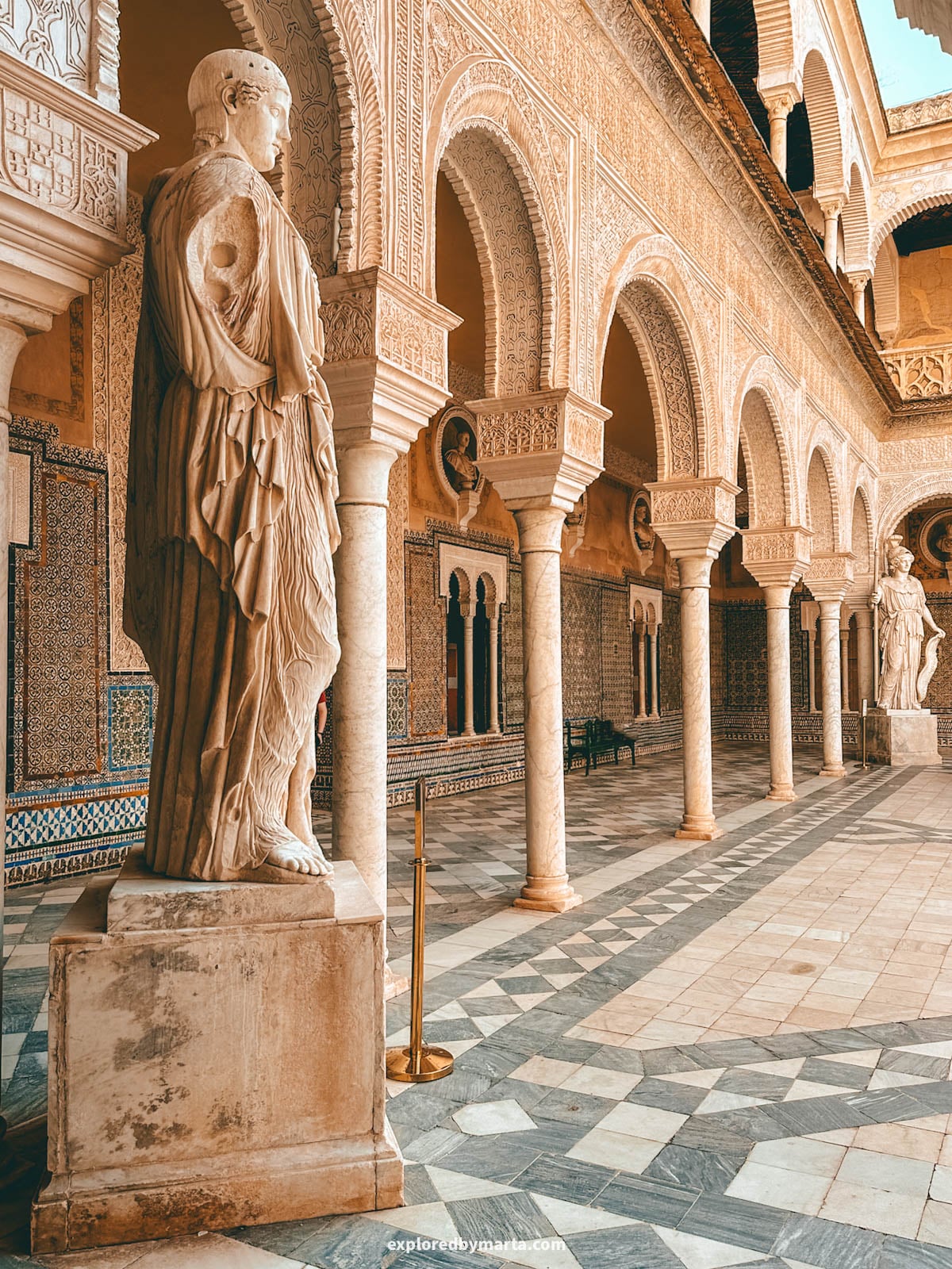 The central courtyard with arches and tilework at Casa de Pilatos in Seville, Spain