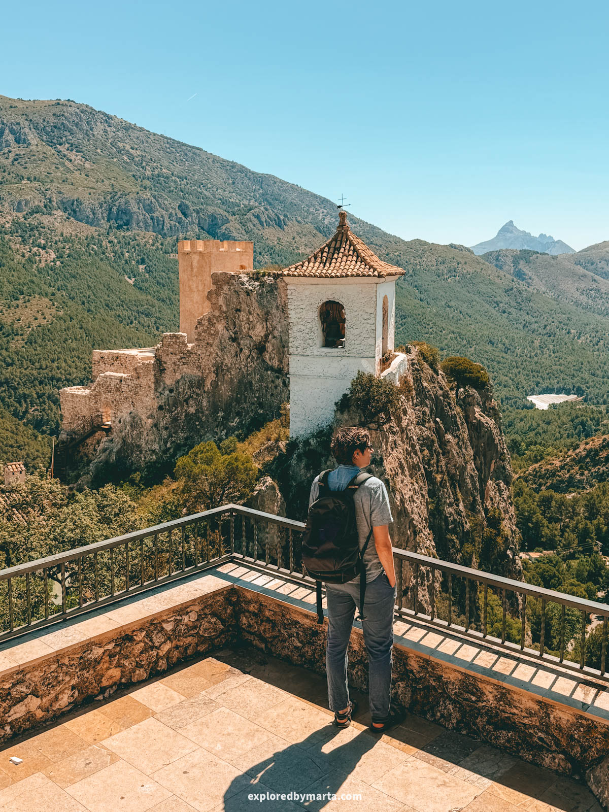The ruins of Castell de la Alcozaiba on the rock seen from Mirador del Calvari in Guadalest, Spain