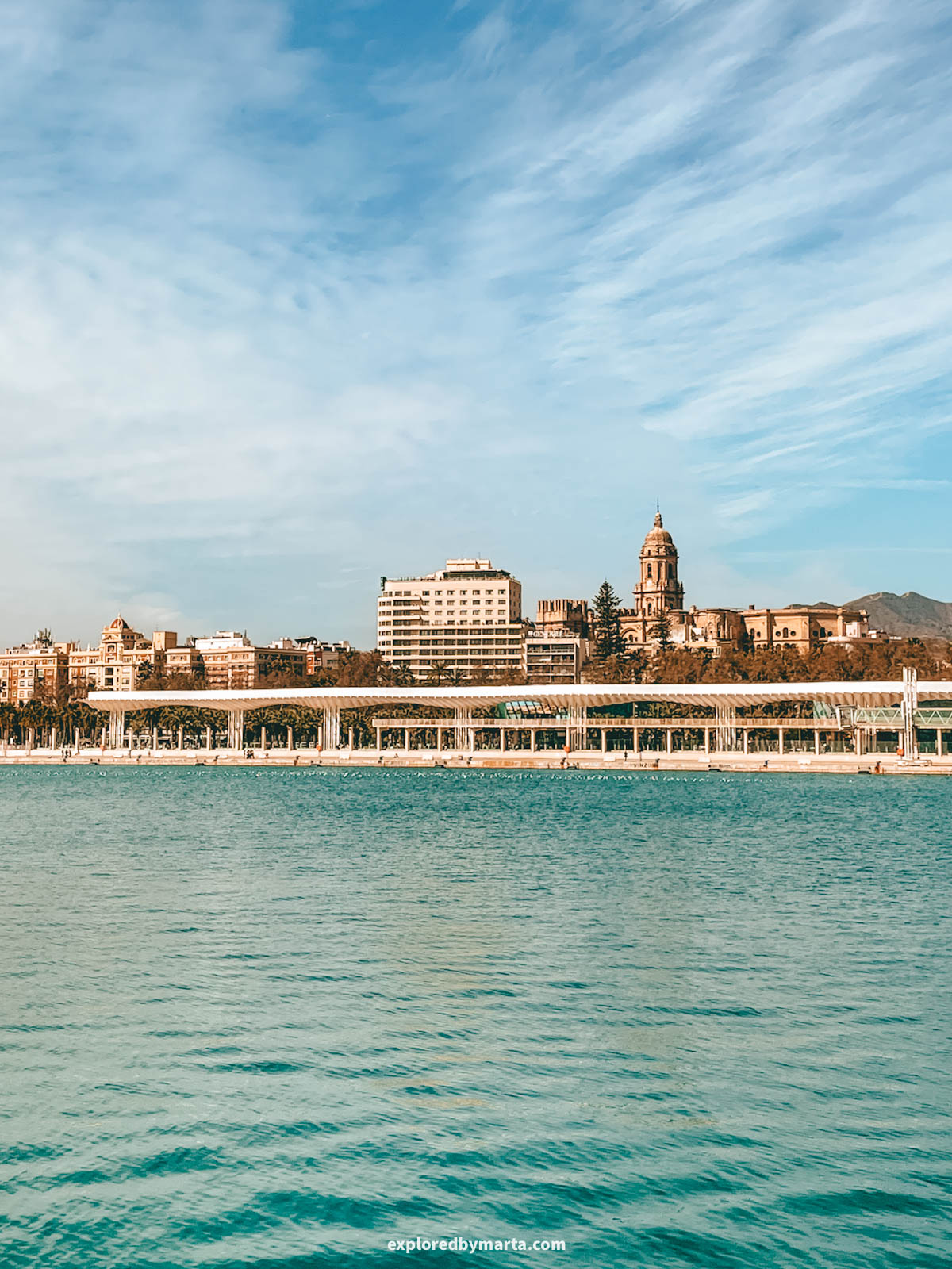 View of Malaga from Muelle Uno near La Farola de Málaga in Malaga, Spain
