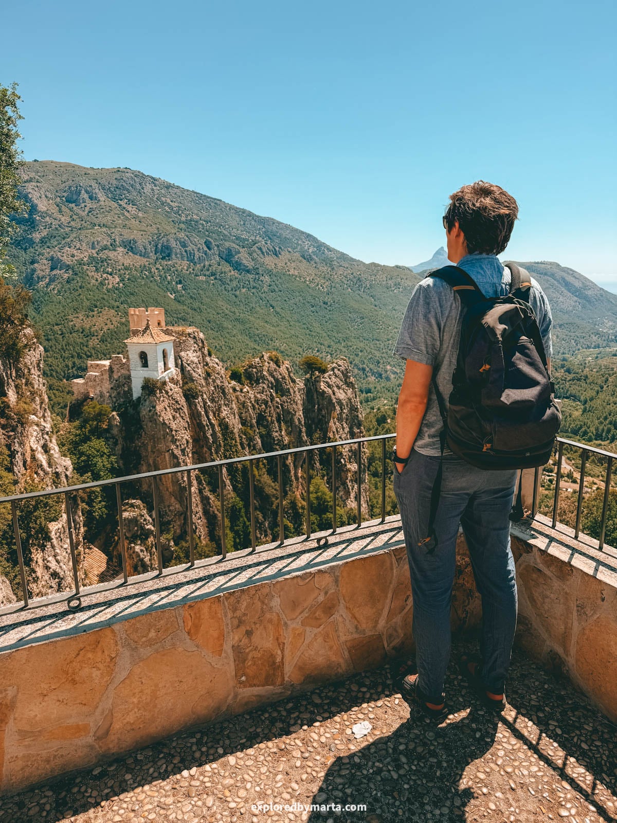 Guadalest bell tower on the rocky crag seen from the cemetery viewpoint in Valencia Region, Spain