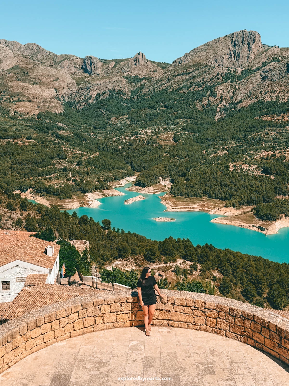 View over the Guadalest reservoir from a stone terrace viewpoint in Guadalest, Spain